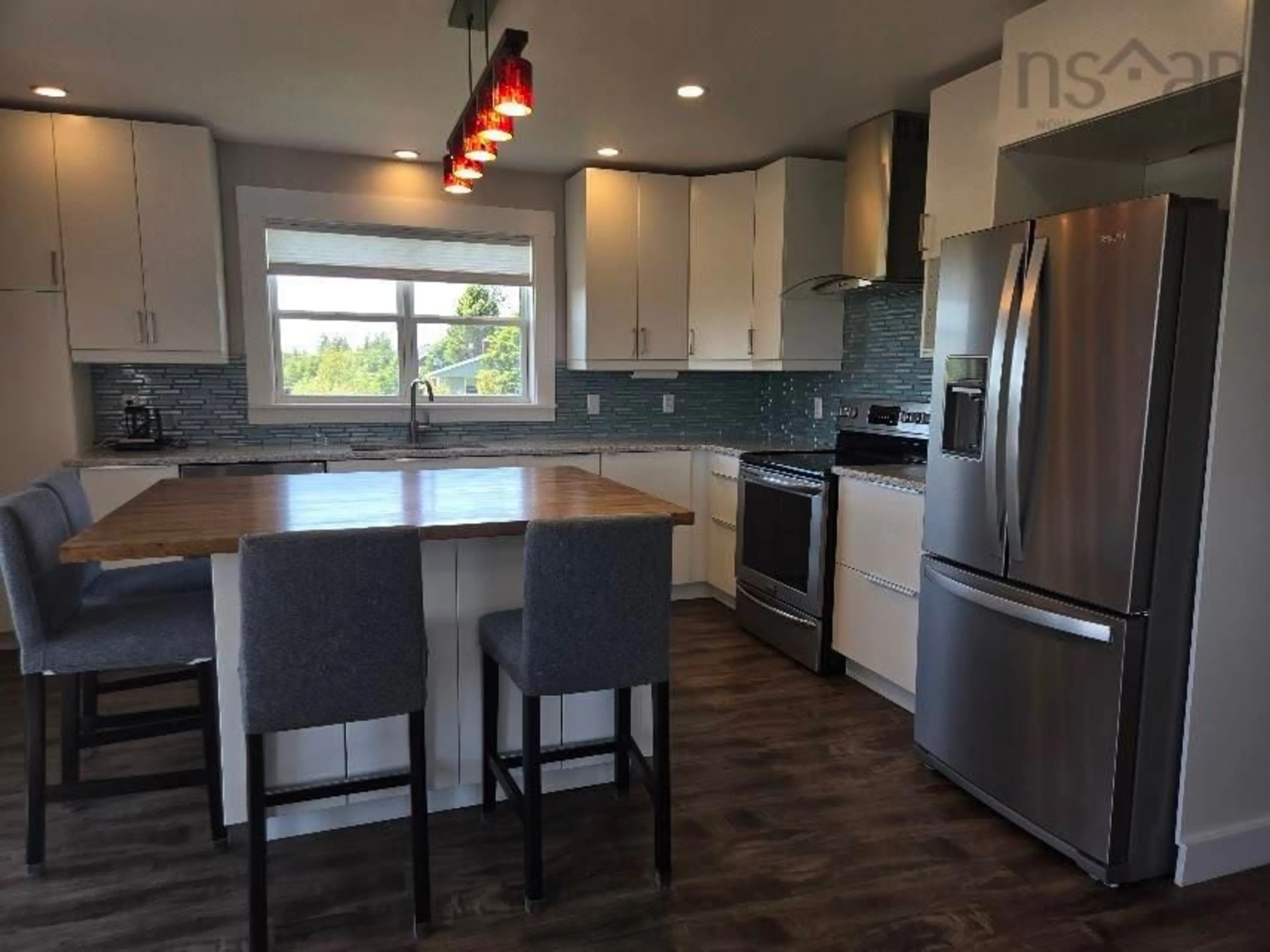 Open concept kitchen, wood/laminate floor for 98 King Lothar Dr, Barrachois Nova Scotia B0K 1V0