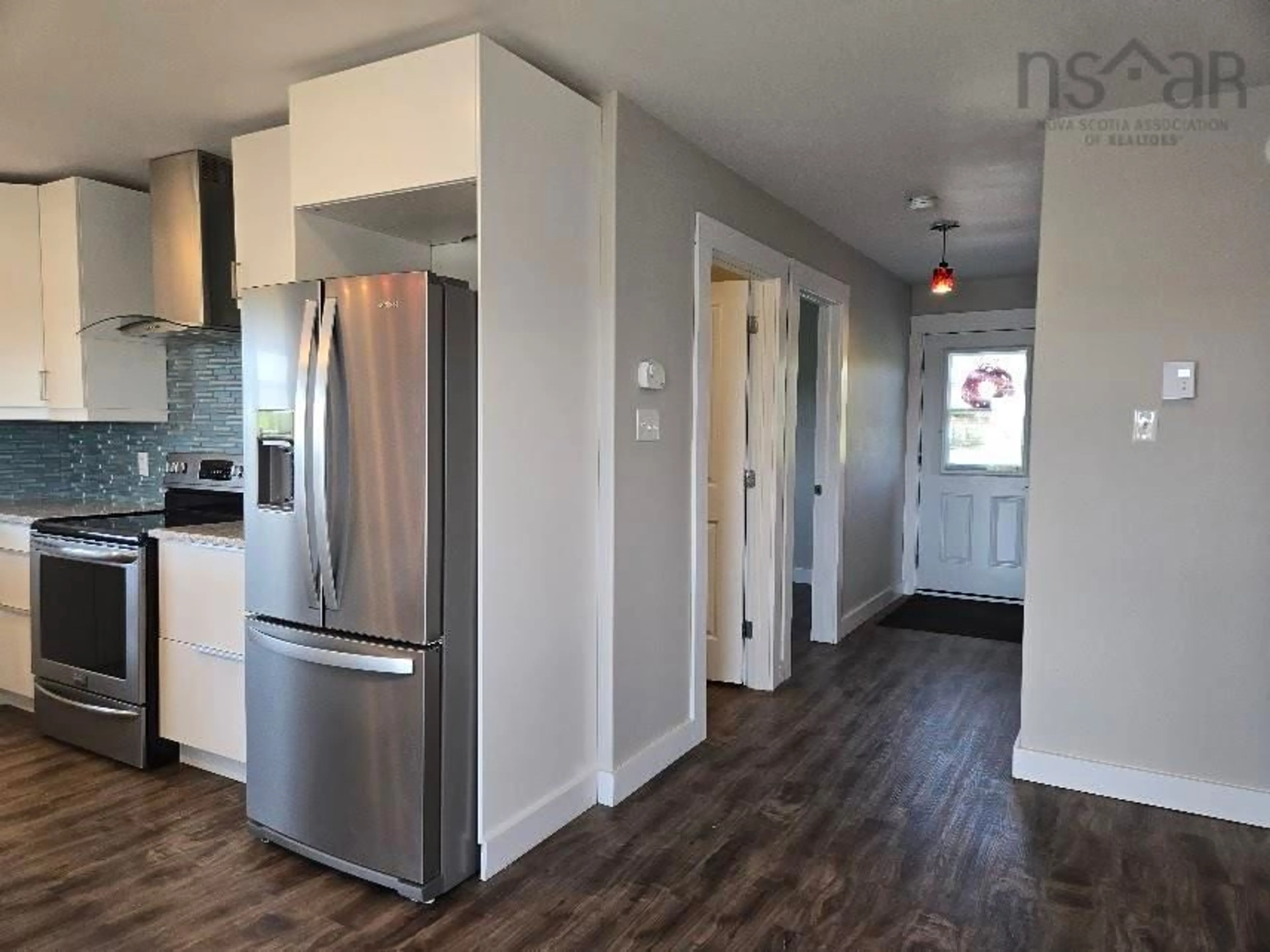 Open concept kitchen, wood/laminate floor for 98 King Lothar Dr, Barrachois Nova Scotia B0K 1V0