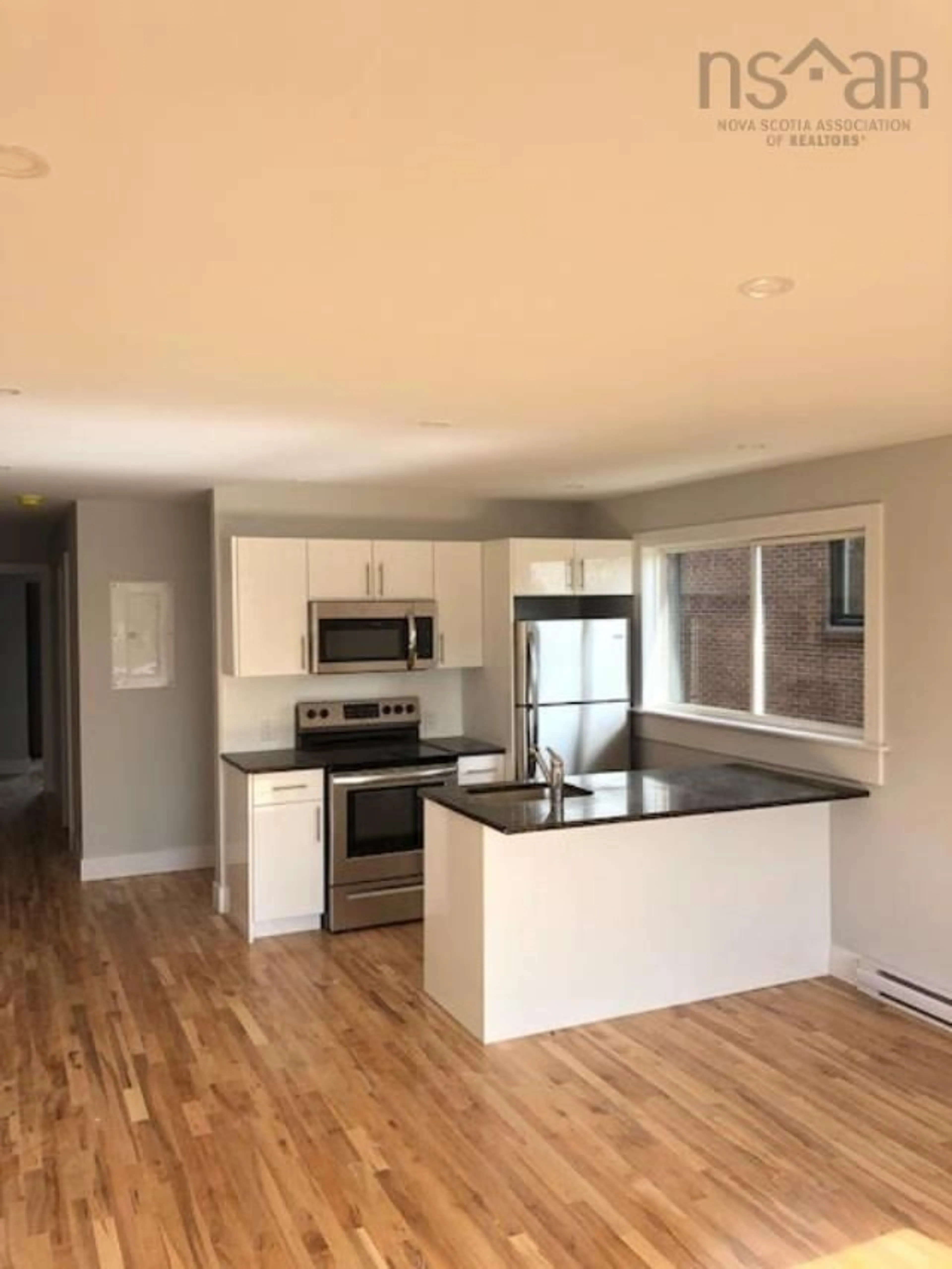 Open concept kitchen, wood/laminate floor for 23 Best St, Dartmouth Nova Scotia B3A 2W9