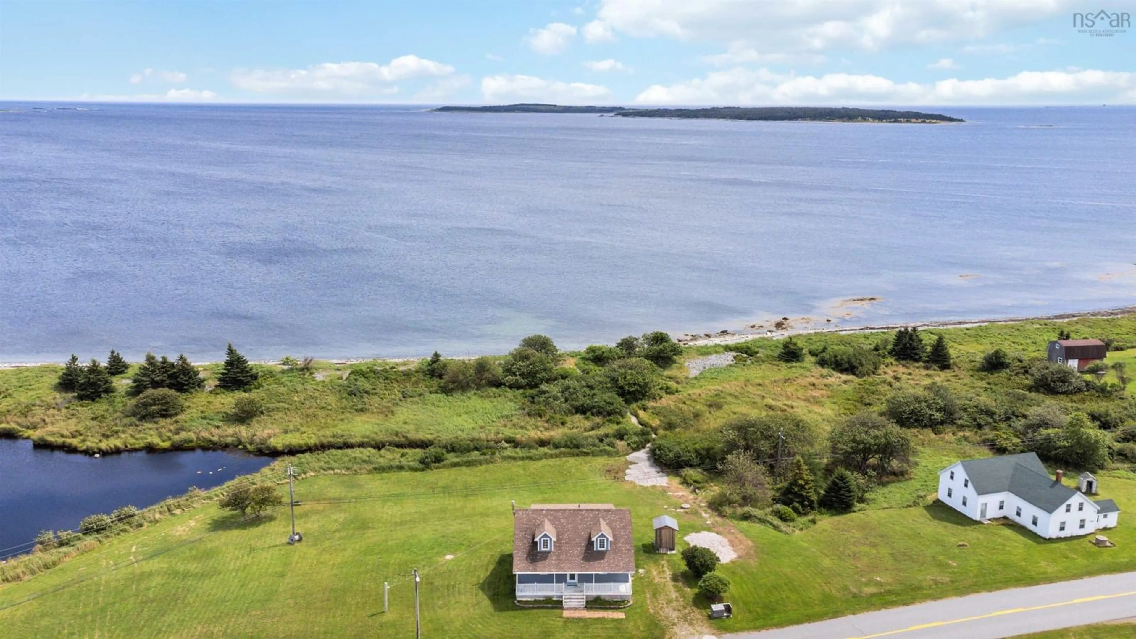A pic from outside/outdoor area/front of a property/back of a property/a pic from drone, water/lake/river/ocean view for 5157 Shore Rd, North East Harbour Nova Scotia B0T 1W0