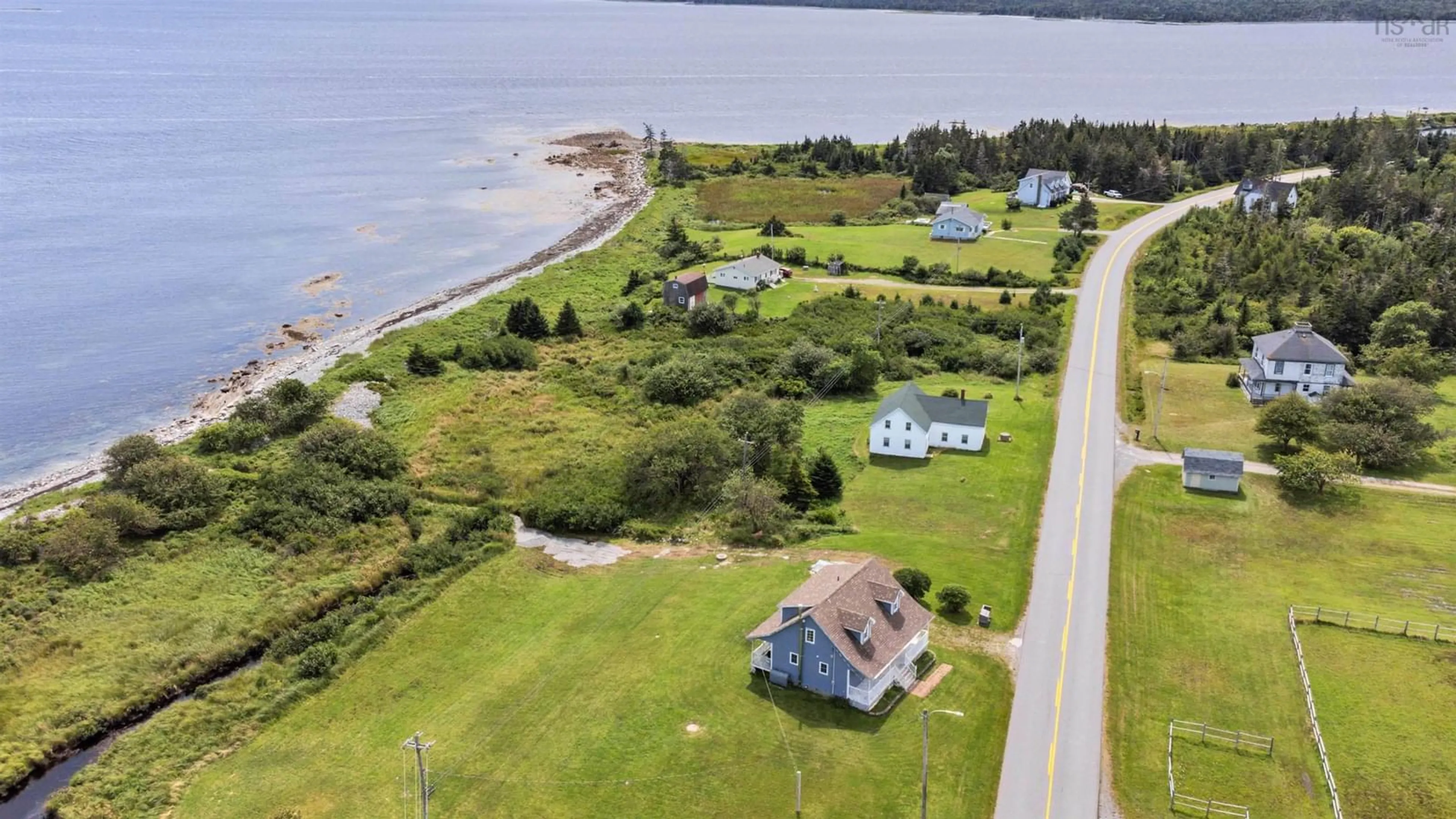 A pic from outside/outdoor area/front of a property/back of a property/a pic from drone, water/lake/river/ocean view for 5157 Shore Rd, North East Harbour Nova Scotia B0T 1W0