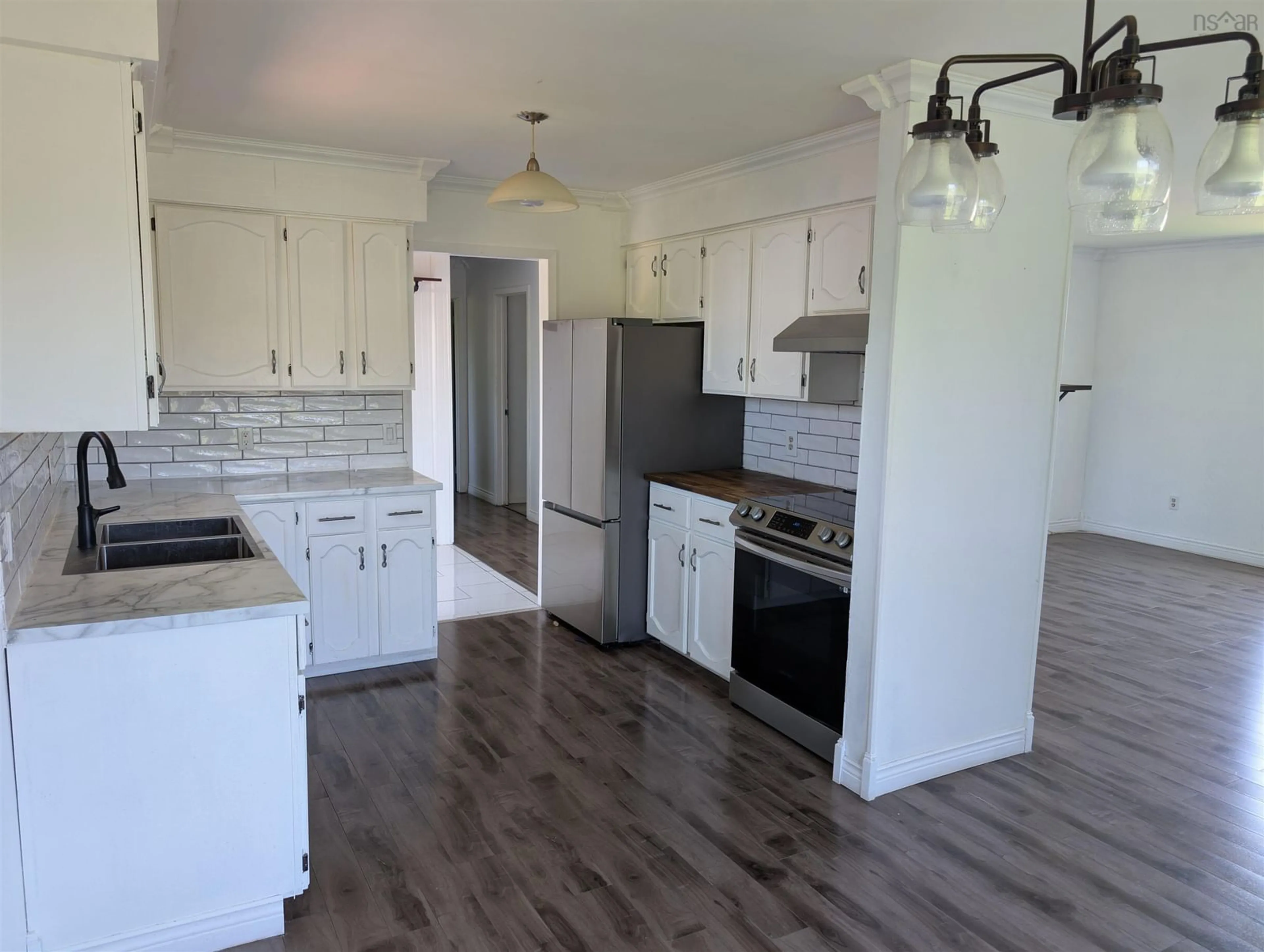Open concept kitchen, wood/laminate floor for 389 Shore Rd, Masstown Nova Scotia B0M 1G0