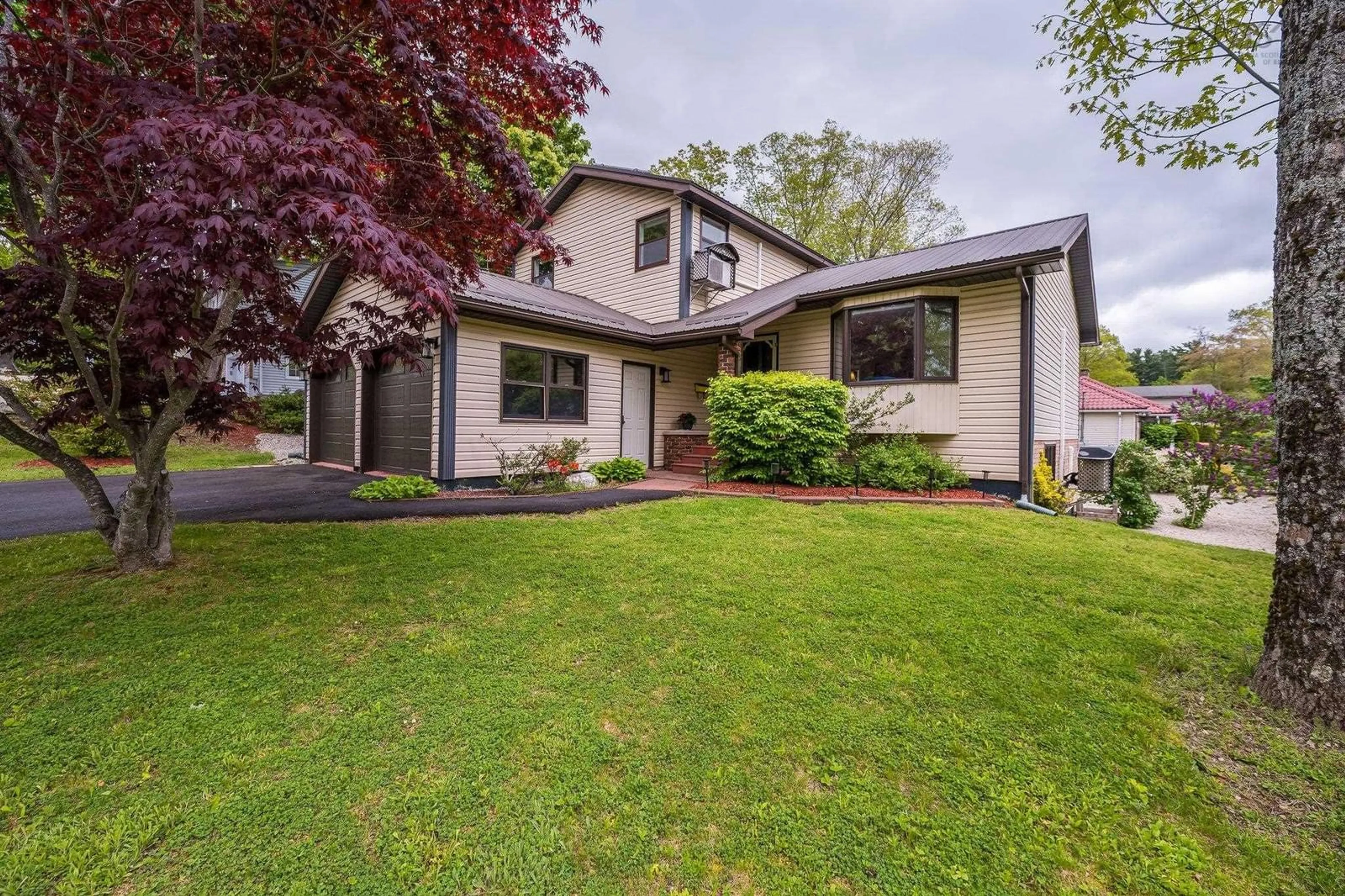 Home with vinyl exterior material, street for 28 Macneil Dr, Bridgewater Nova Scotia B4V 3Y8