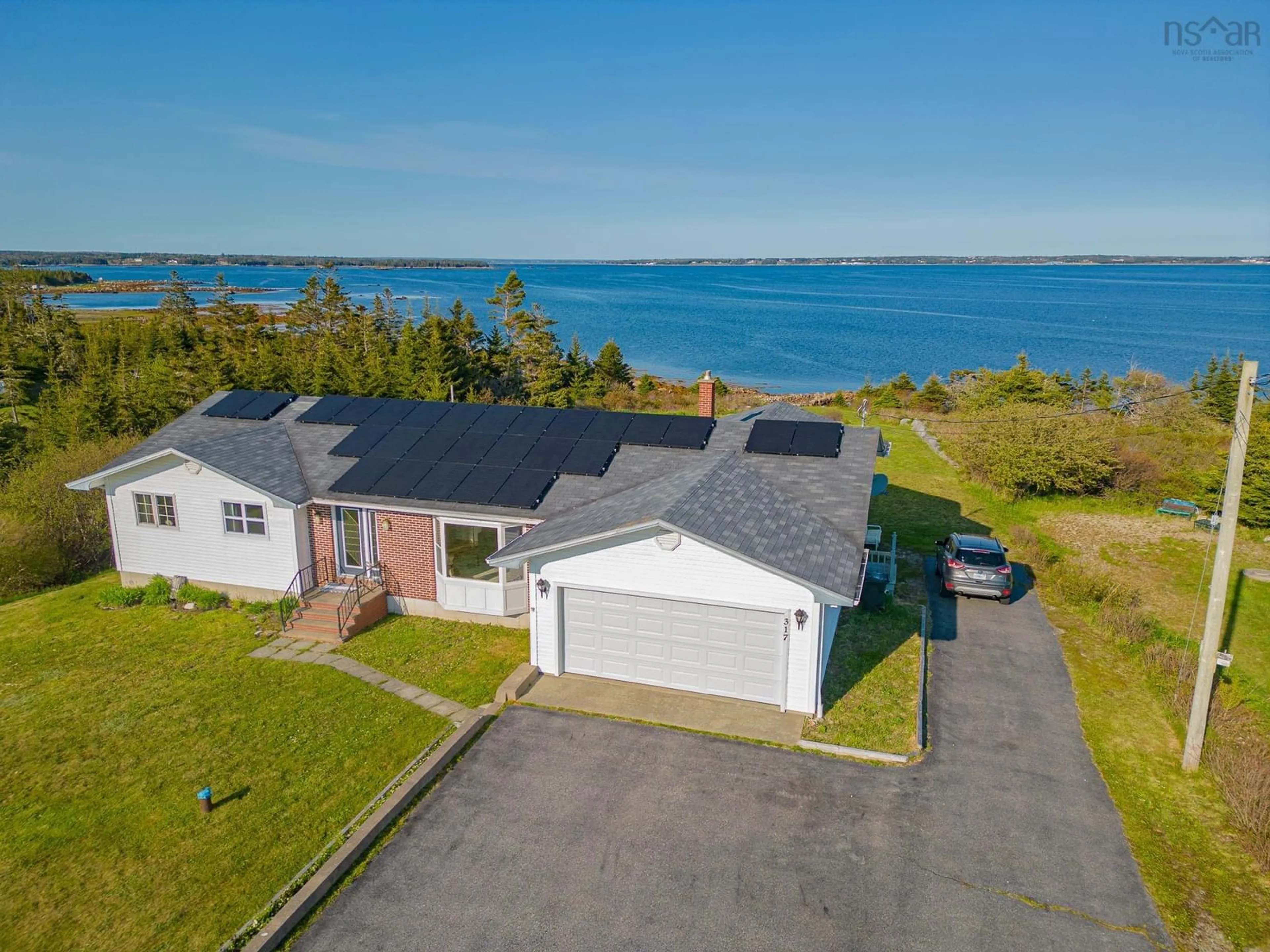 A pic from outside/outdoor area/front of a property/back of a property/a pic from drone, water/lake/river/ocean view for 317 Bear Point Rd, Bear Point Nova Scotia B0W 3B0