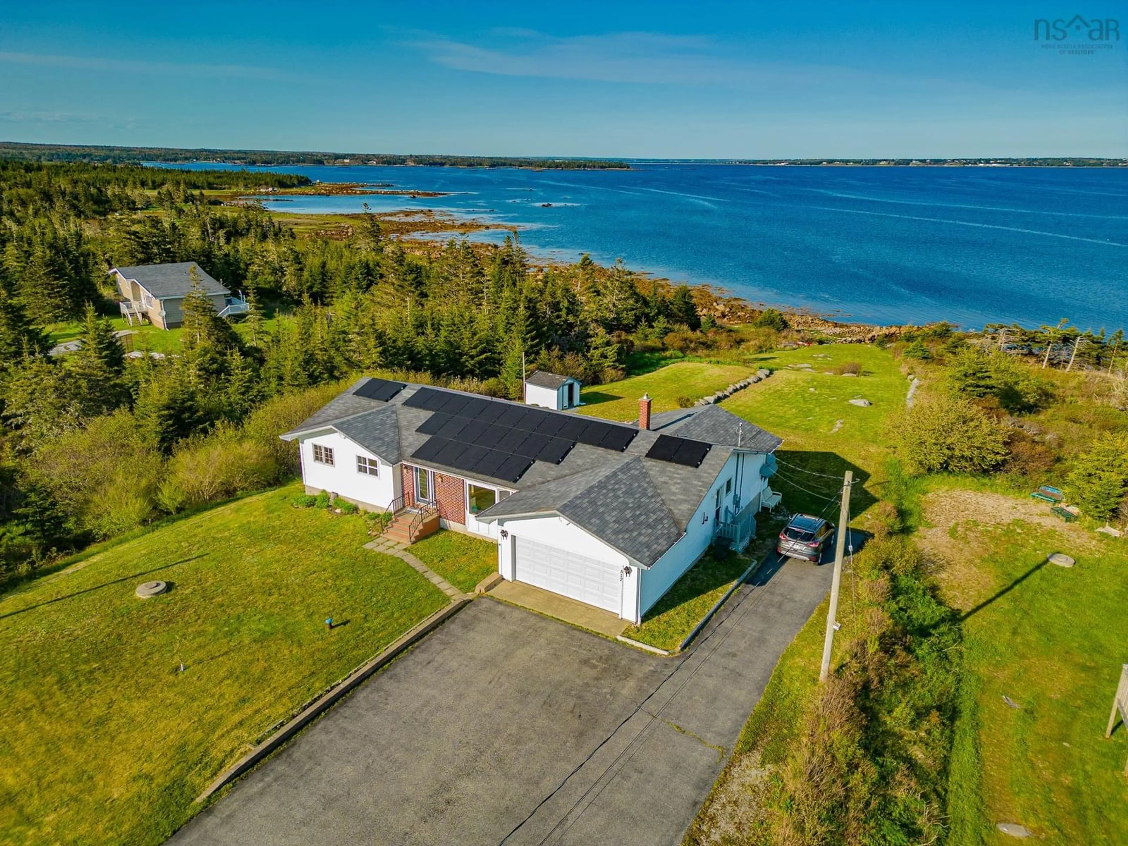 A pic from outside/outdoor area/front of a property/back of a property/a pic from drone, water/lake/river/ocean view for 317 Bear Point Rd, Bear Point Nova Scotia B0W 3B0
