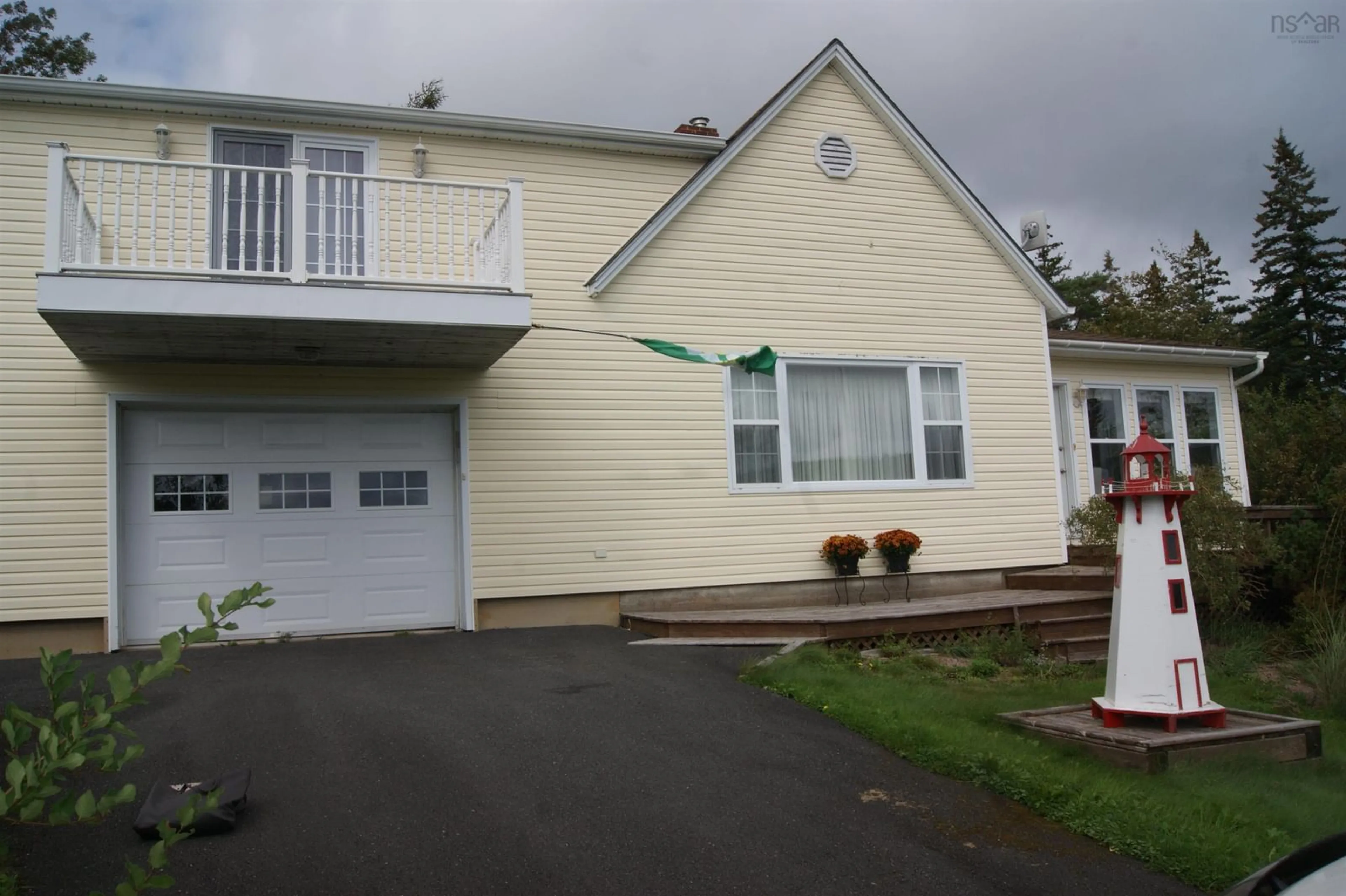 Home with vinyl exterior material, street for 1011 Highway 205, Baddeck Bay Nova Scotia B2A 3L3