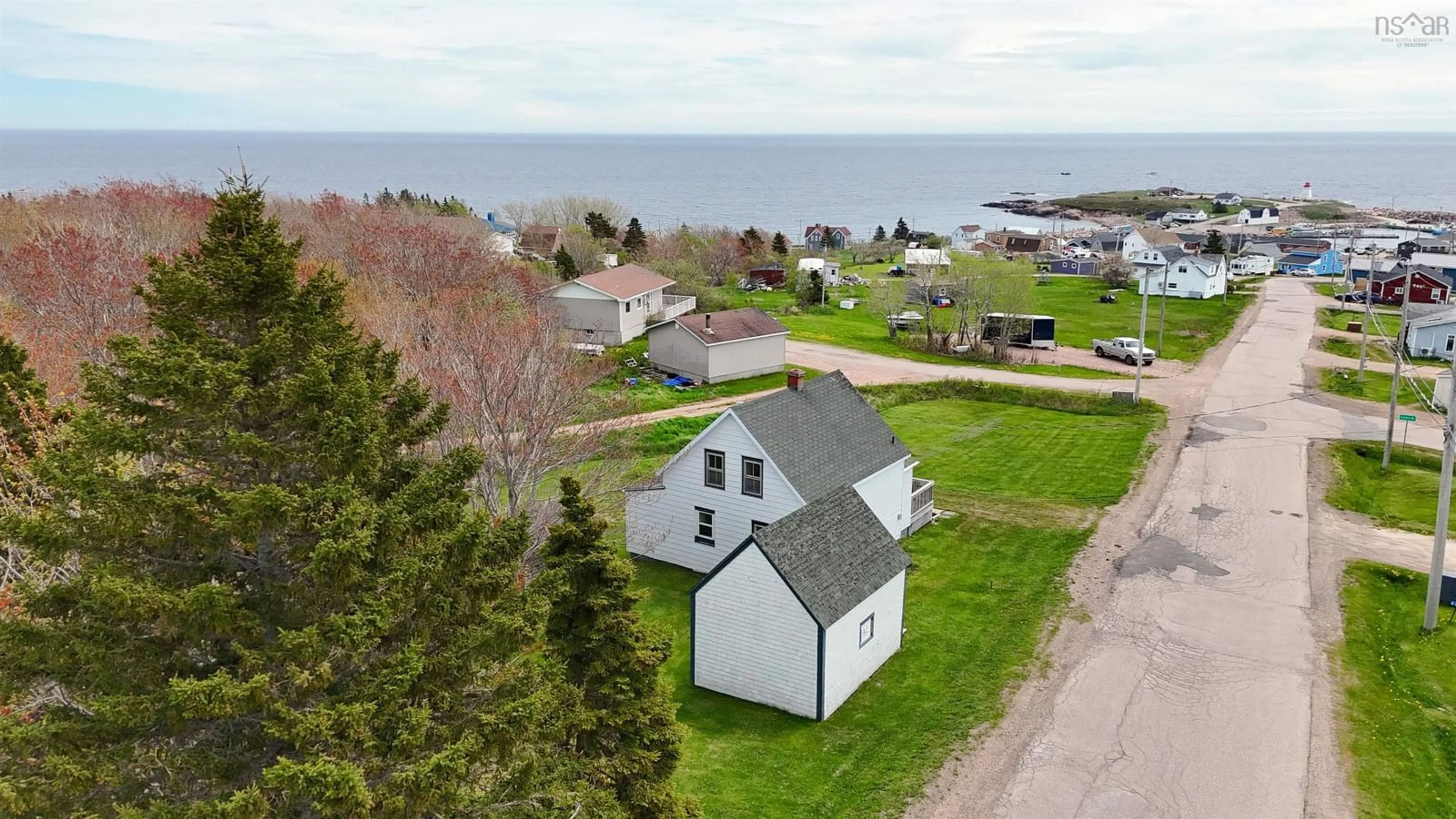 A pic from outside/outdoor area/front of a property/back of a property/a pic from drone, water/lake/river/ocean view for 64 Ocean View Dr, Neils Harbour Nova Scotia B0C 1N0