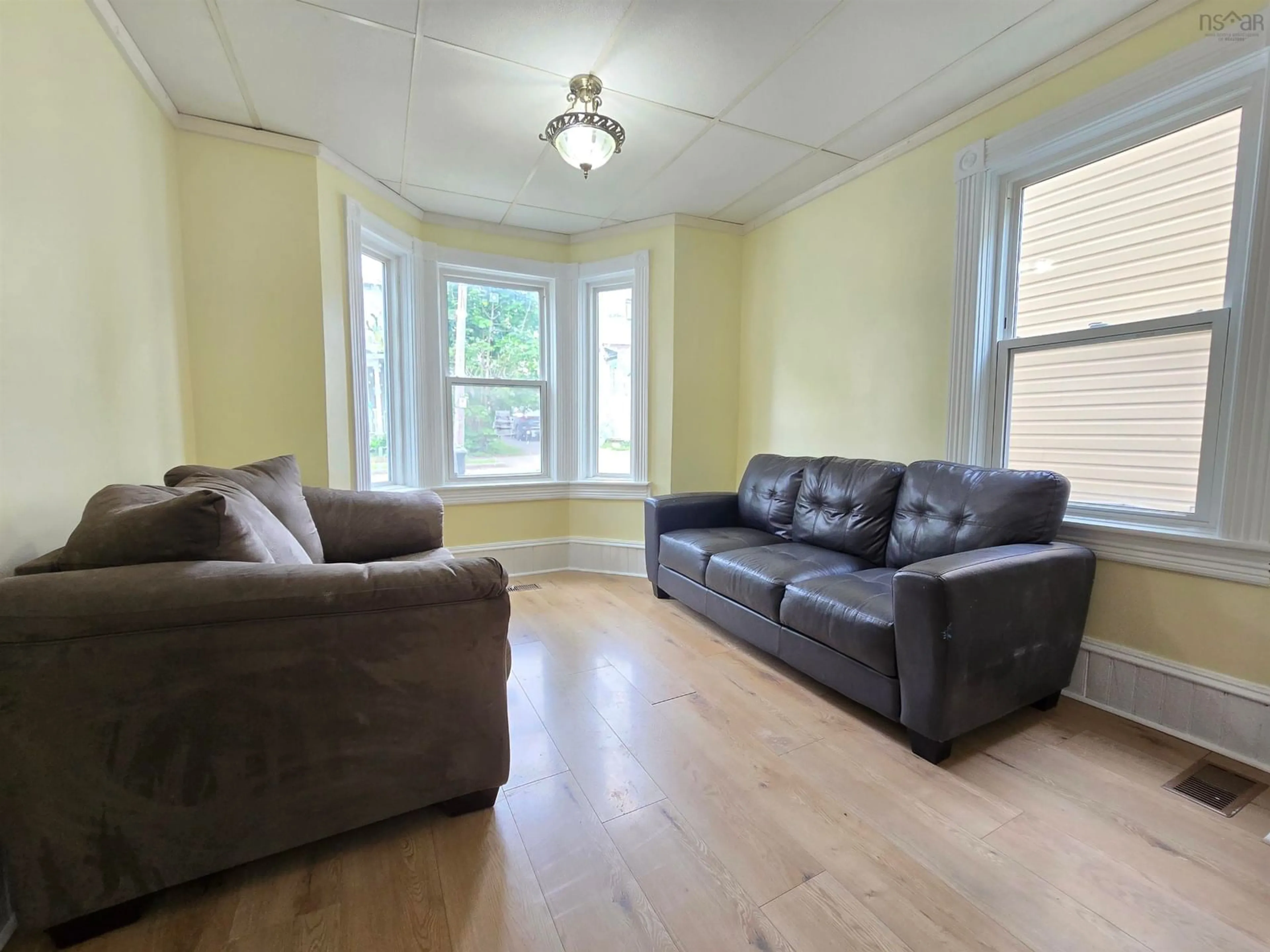 Living room with furniture, wood/laminate floor for 459 Bentinck St, Sydney Nova Scotia B1S 2Y8
