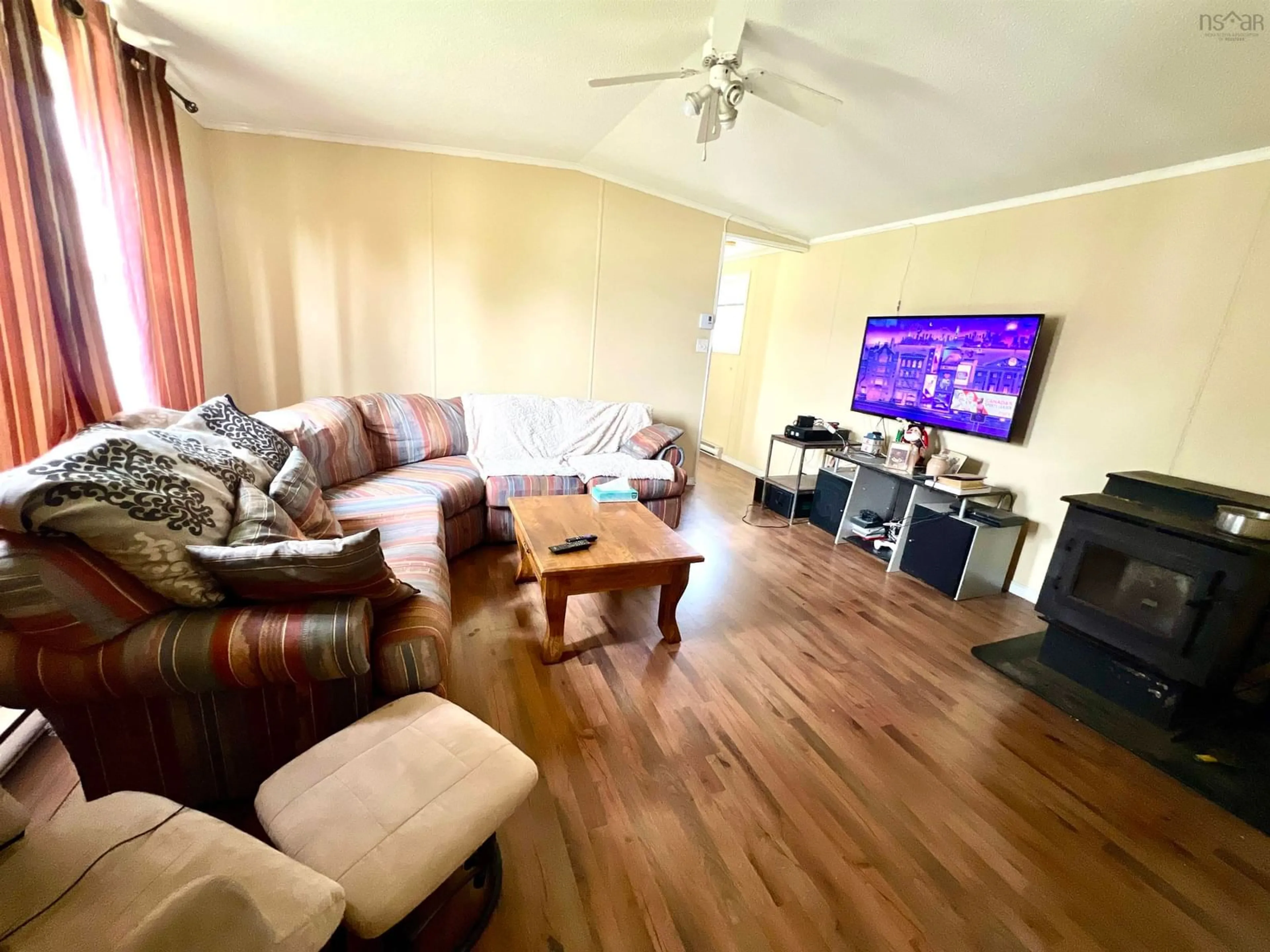 Living room with furniture, wood/laminate floor for 3 Whispering Pines Pk, Mira Nova Scotia B1M 1C7