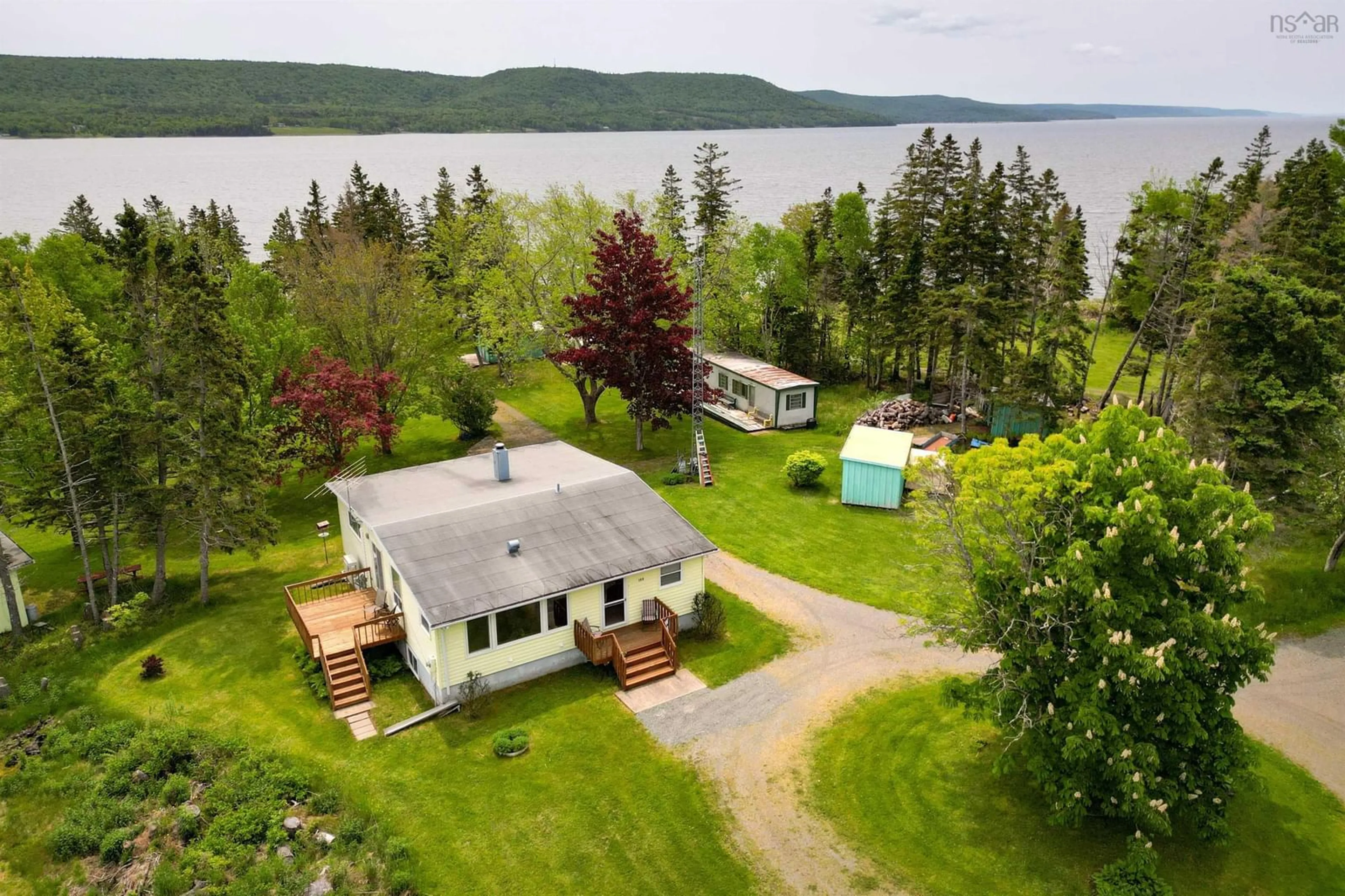 A pic from outside/outdoor area/front of a property/back of a property/a pic from drone, water/lake/river/ocean view for 100 Barrington Lane, North Side East Bay Nova Scotia B1J 1H1