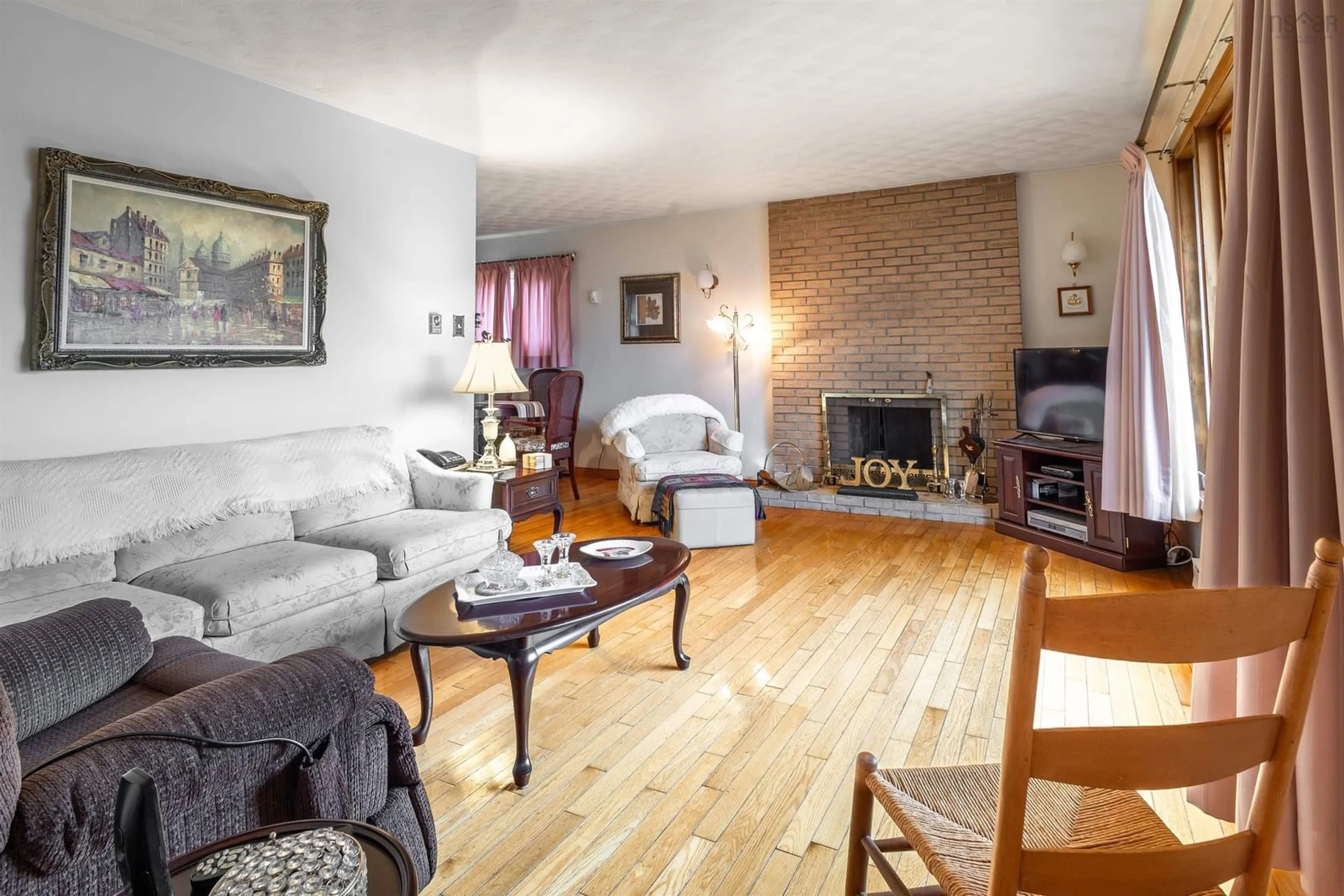 Living room with furniture, wood/laminate floor for 55 Beechwood Cres, Sydney Nova Scotia B1S 1V9