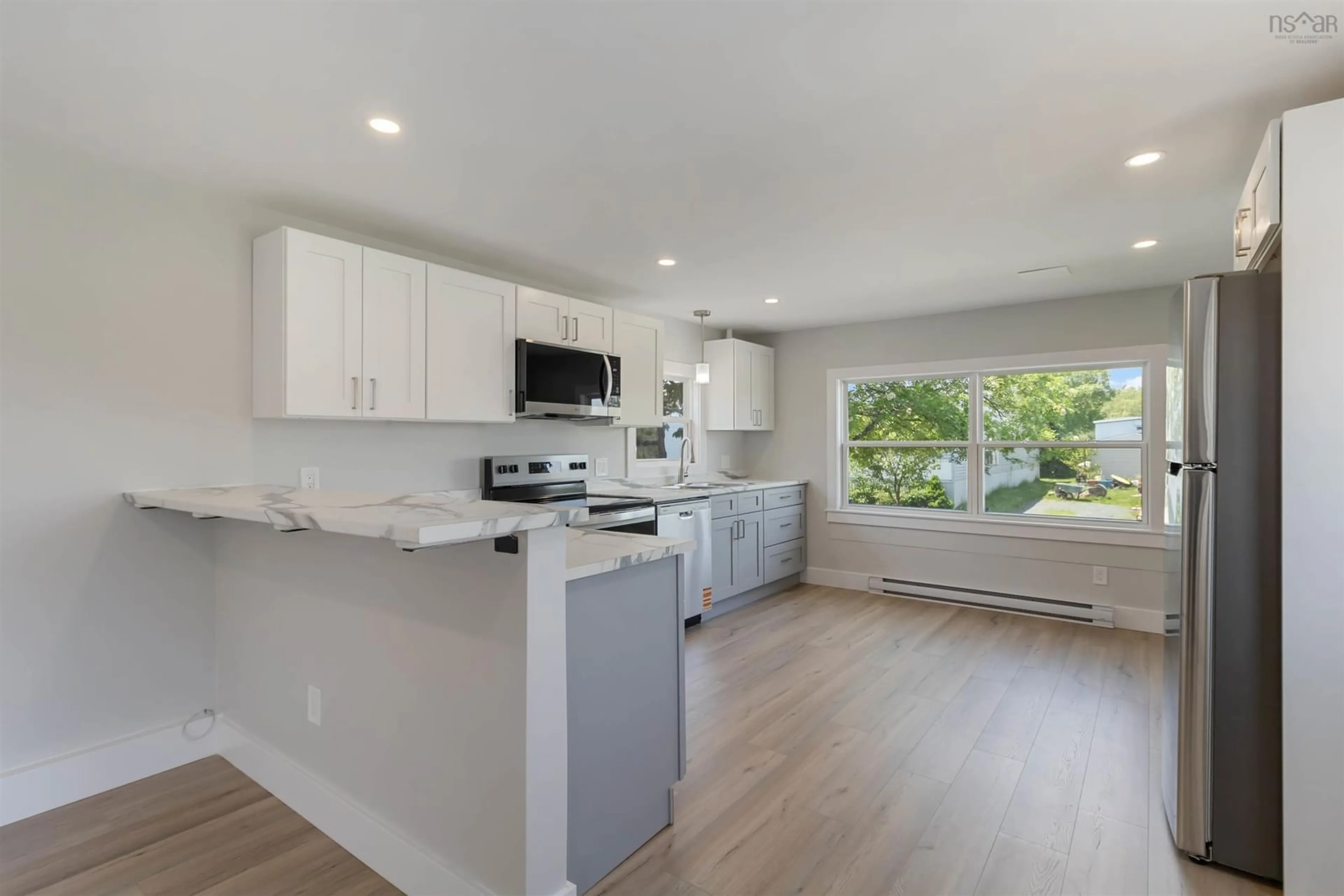 Open concept kitchen, wood/laminate floor for 30 Cocoa St, Forest Hills Nova Scotia B2W 4W7