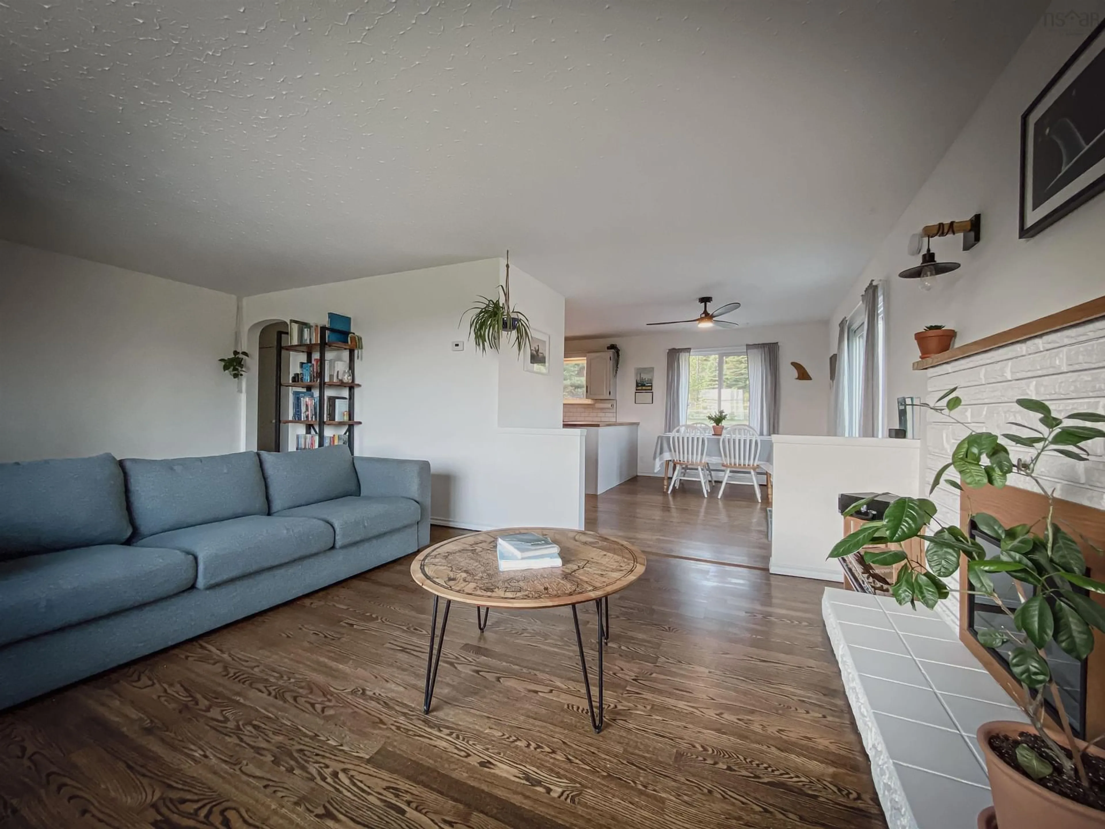 Living room with furniture, wood/laminate floor for 1070 Cow Bay Rd, Cow Bay Nova Scotia B3G 1L5