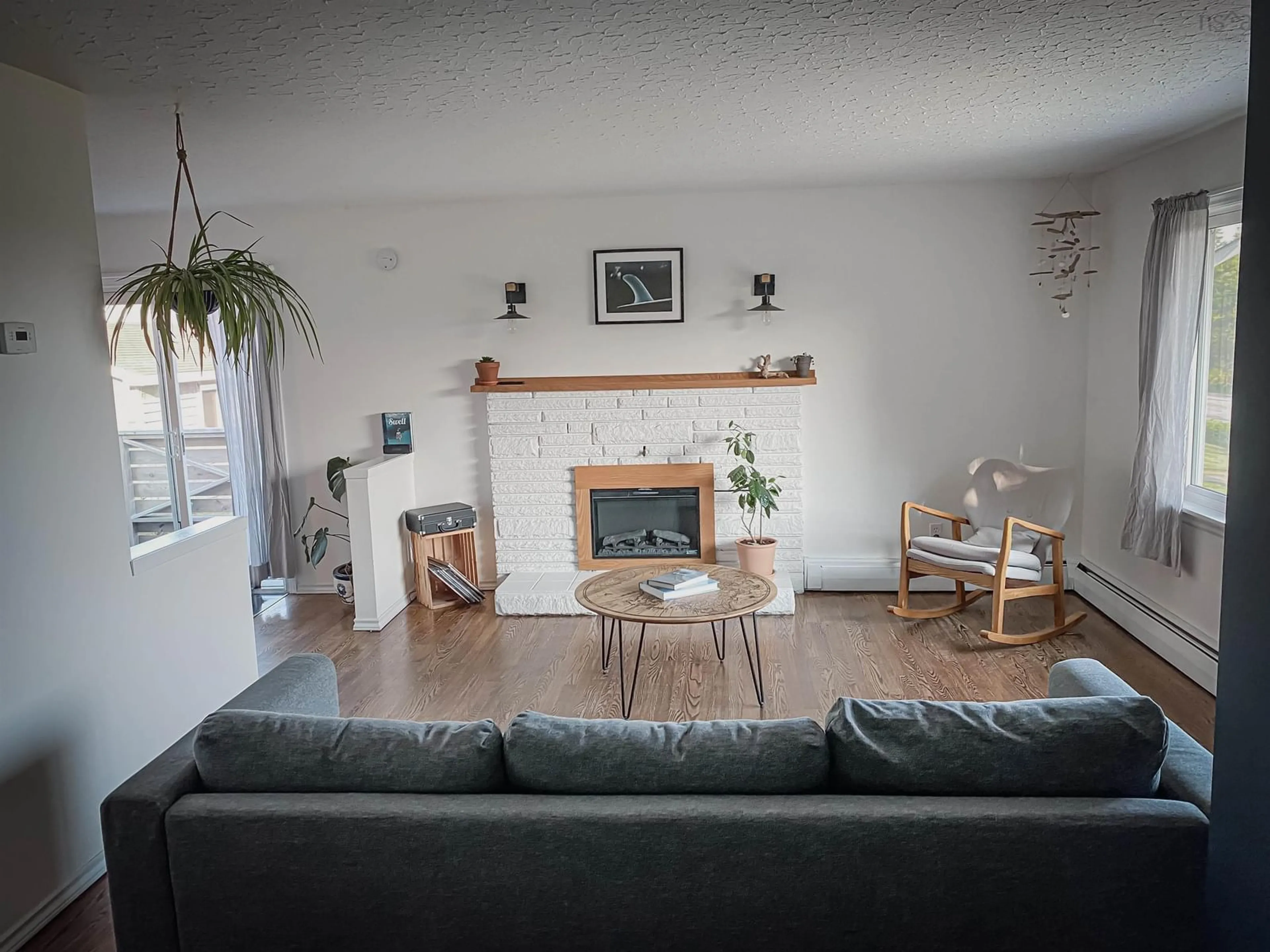 Living room with furniture, wood/laminate floor for 1070 Cow Bay Rd, Cow Bay Nova Scotia B3G 1L5