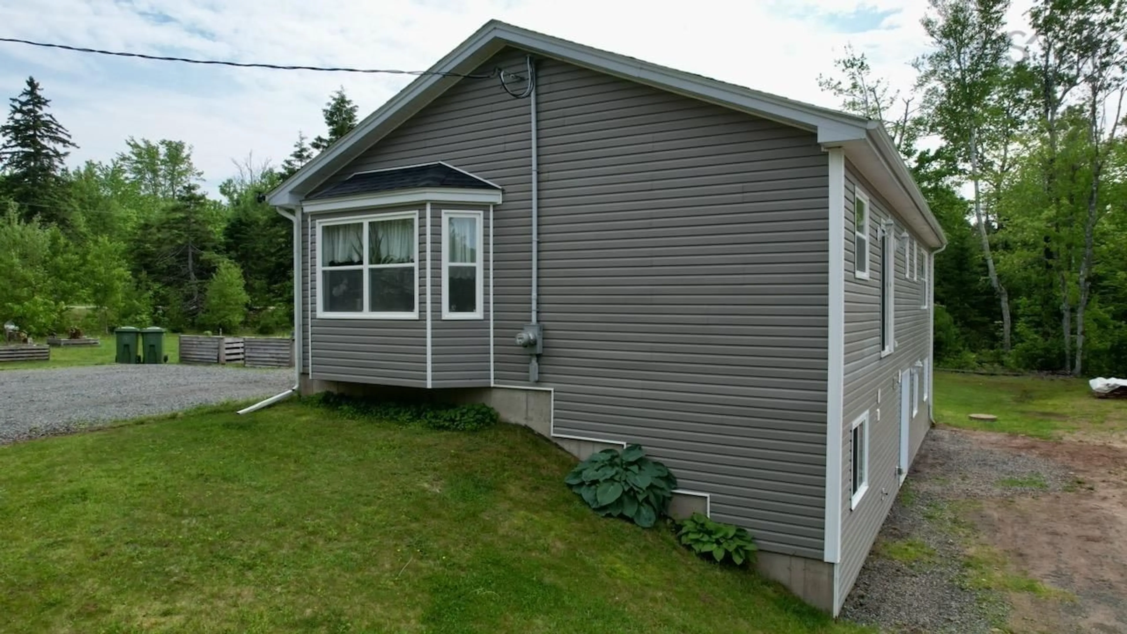 Home with vinyl exterior material, street for 10205 204 Hwy, South Victoria Nova Scotia B0M 1P0