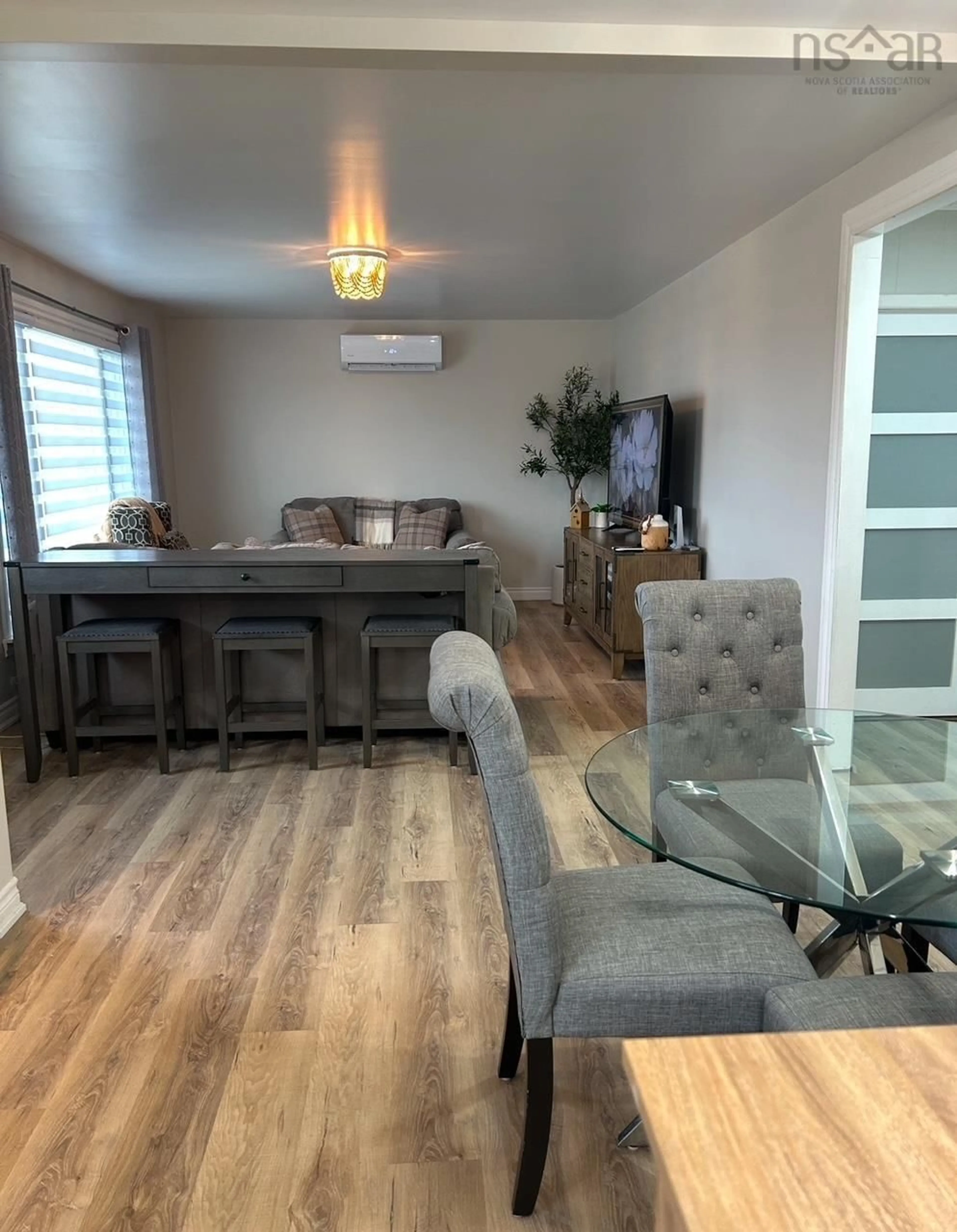 Living room with furniture, wood/laminate floor for 4650 Shore Rd, Lismore Nova Scotia B0K 1G0