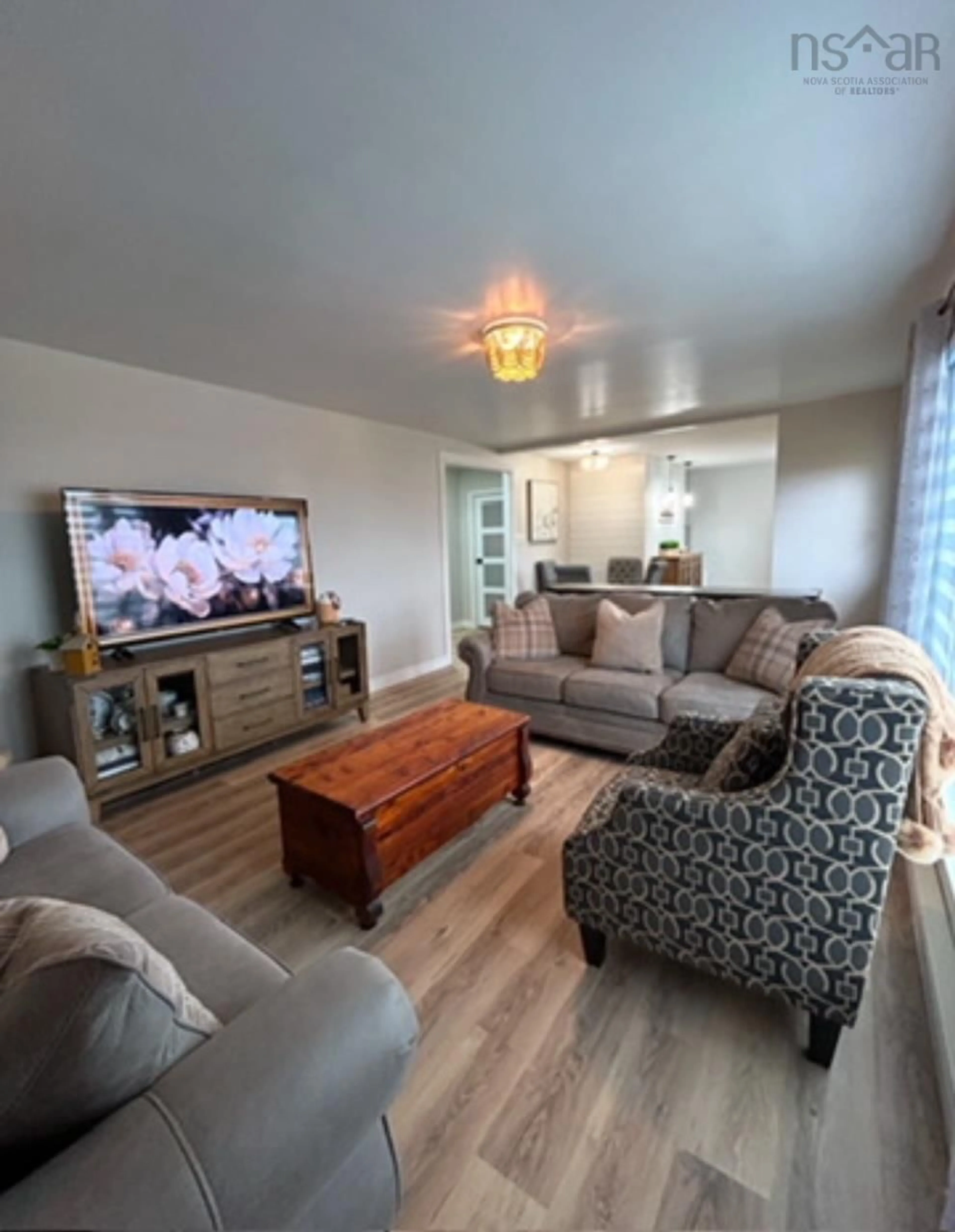 Living room with furniture, wood/laminate floor for 4650 Shore Rd, Lismore Nova Scotia B0K 1G0