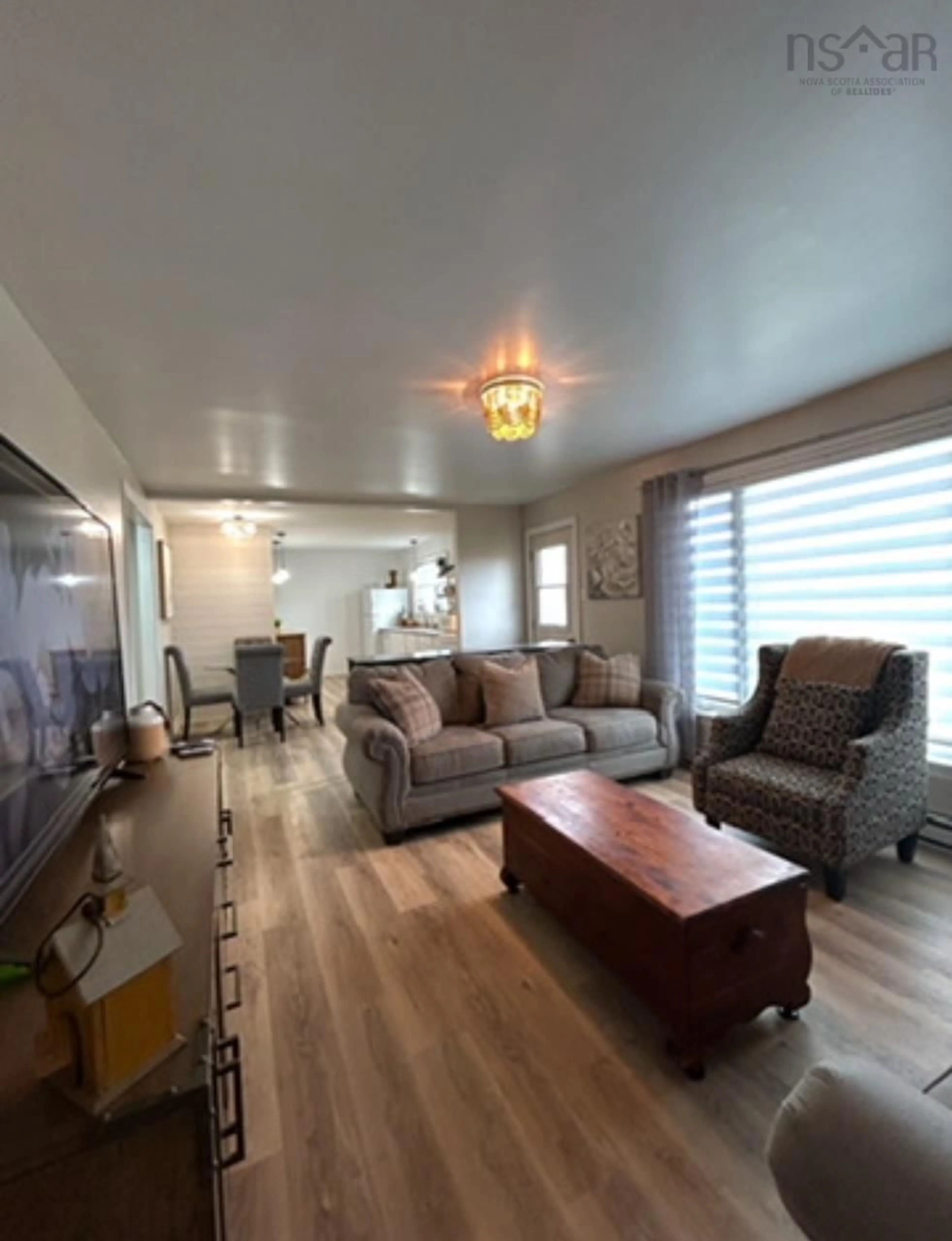 Living room with furniture, wood/laminate floor for 4650 Shore Rd, Lismore Nova Scotia B0K 1G0