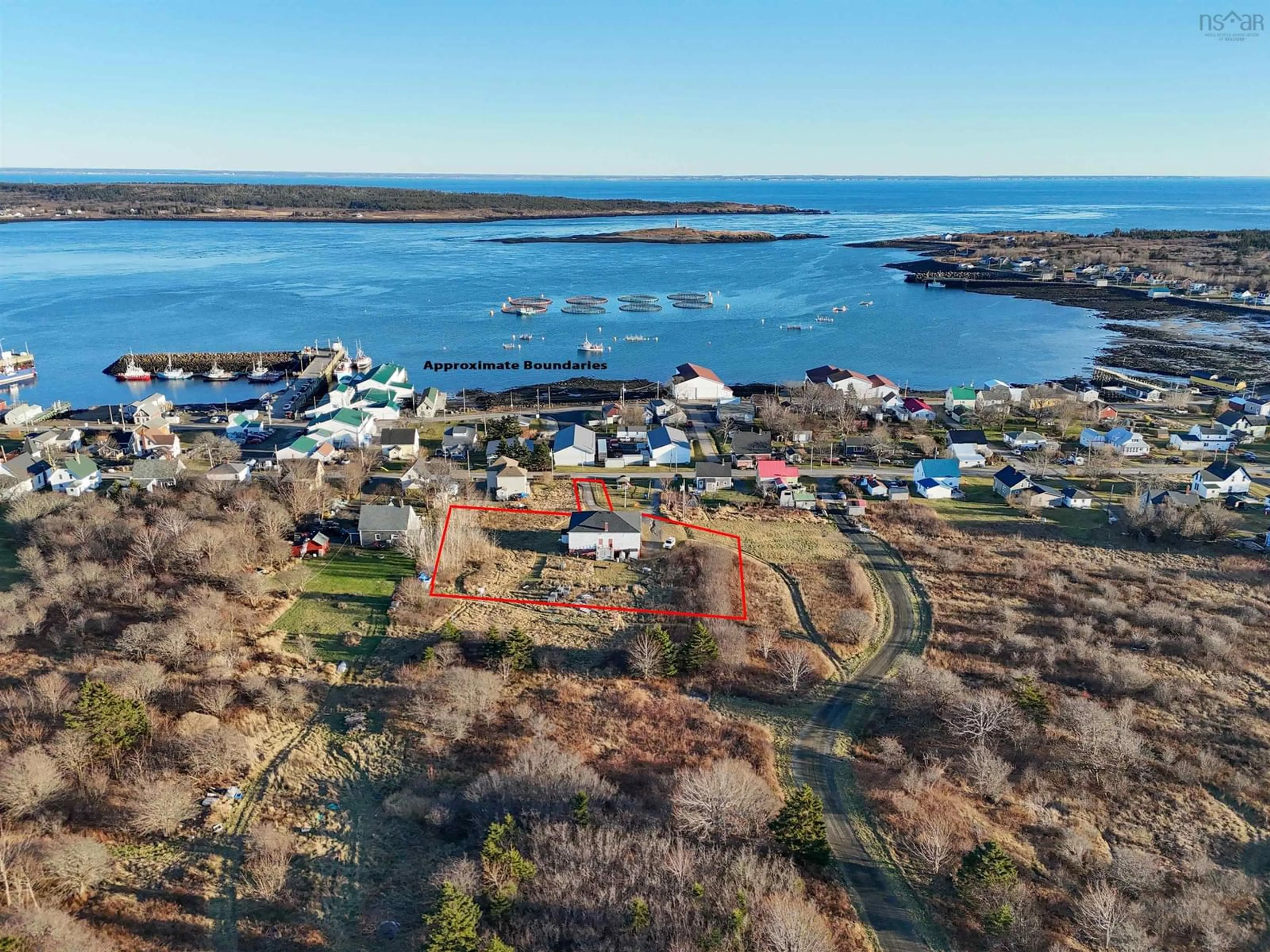 A pic from outside/outdoor area/front of a property/back of a property/a pic from drone, water/lake/river/ocean view for 63 Second Street, Westport Nova Scotia B0V 1H0