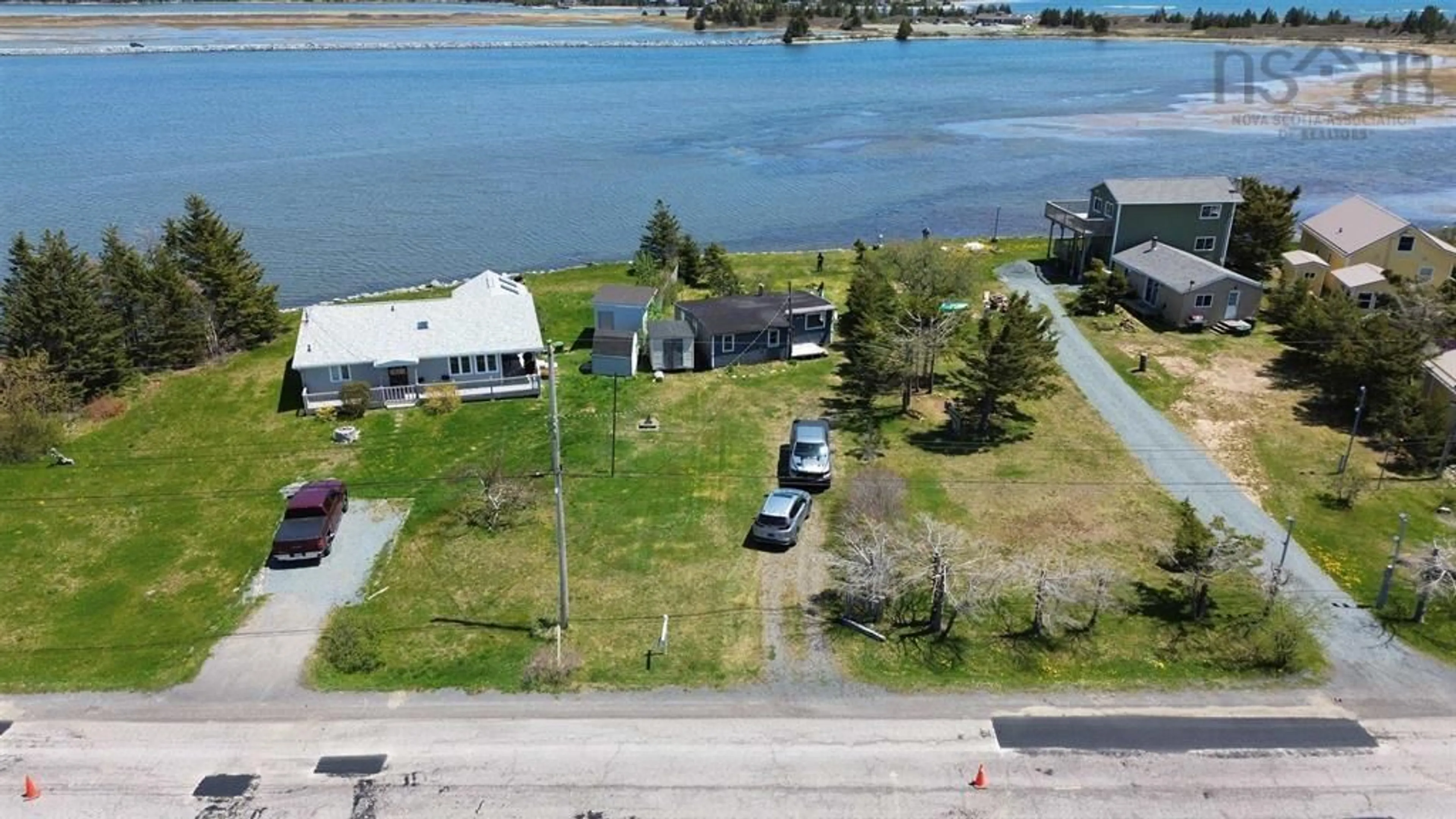 A pic from outside/outdoor area/front of a property/back of a property/a pic from drone, water/lake/river/ocean view for 2353 Cow Bay Rd, Cow Bay Nova Scotia B3G 1K8