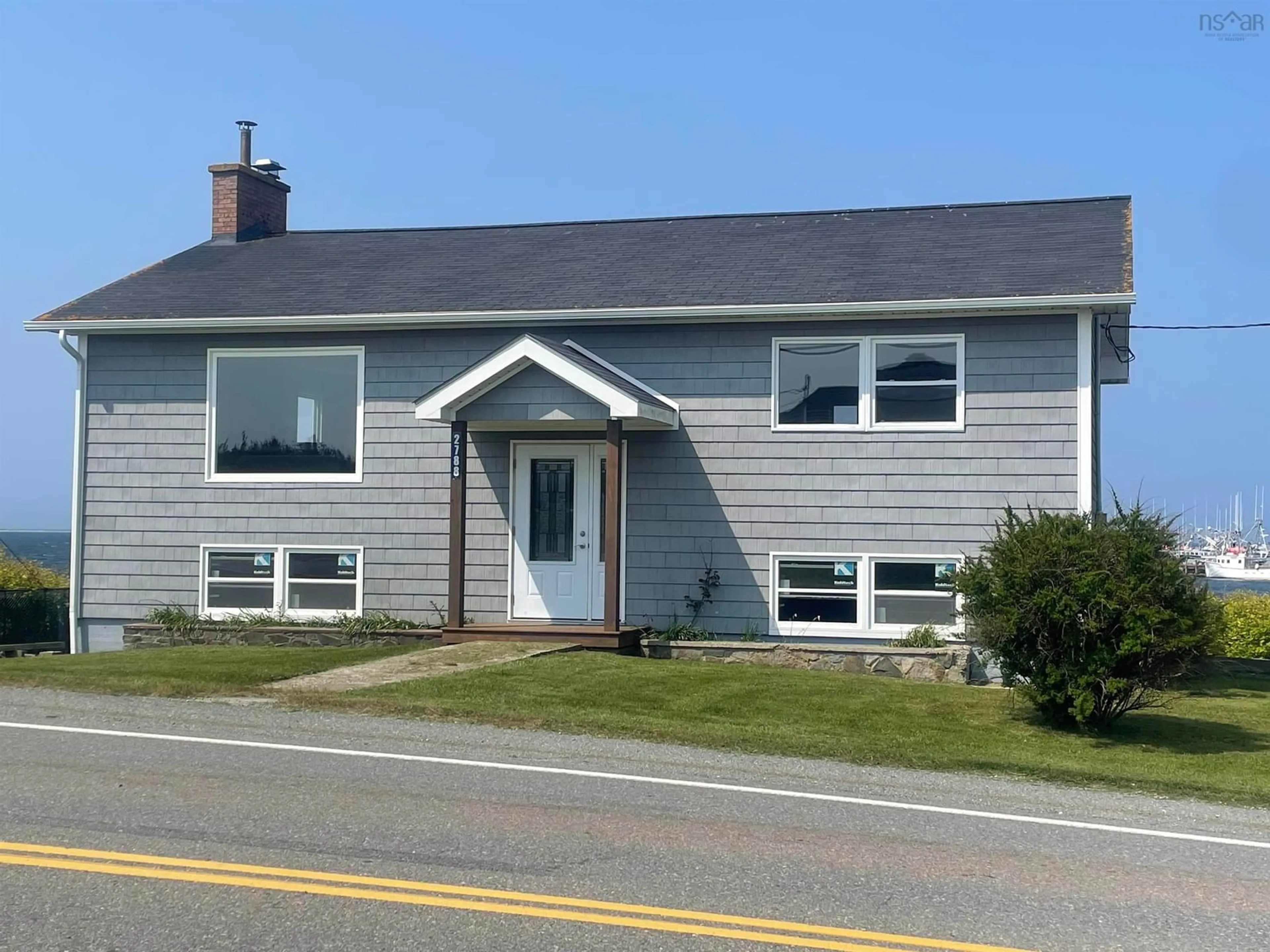 Home with vinyl exterior material, street for 2788 Main Street St, Clark's Harbour Nova Scotia B0W 1P0