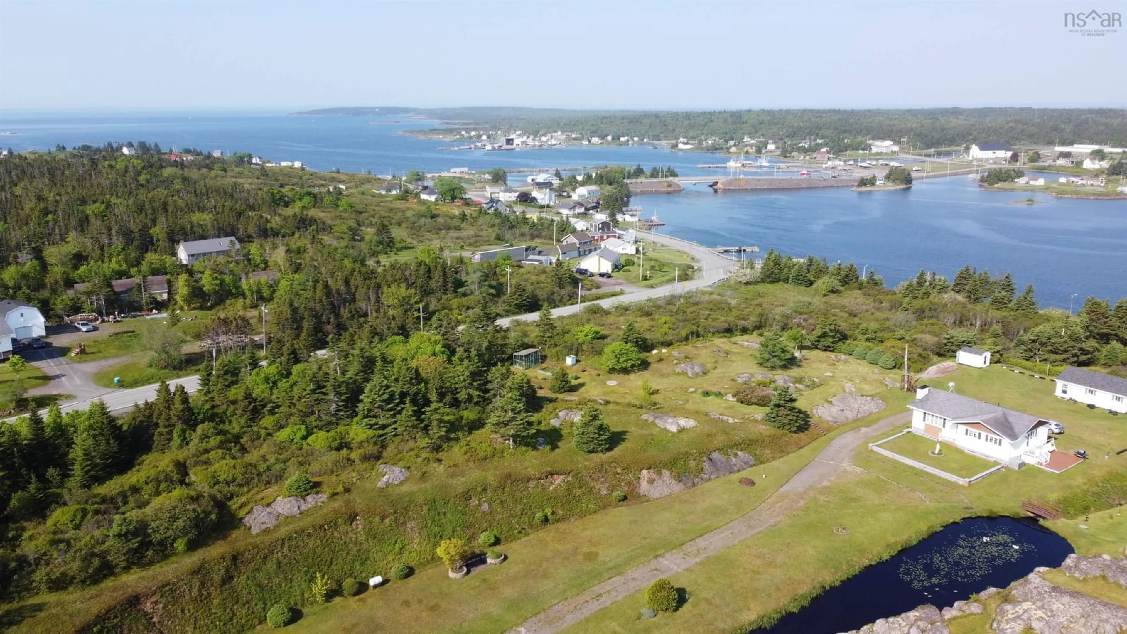 A pic from outside/outdoor area/front of a property/back of a property/a pic from drone, water/lake/river/ocean view for 3817 Highway 206, Petit-De-Grat Nova Scotia B0E 2L0
