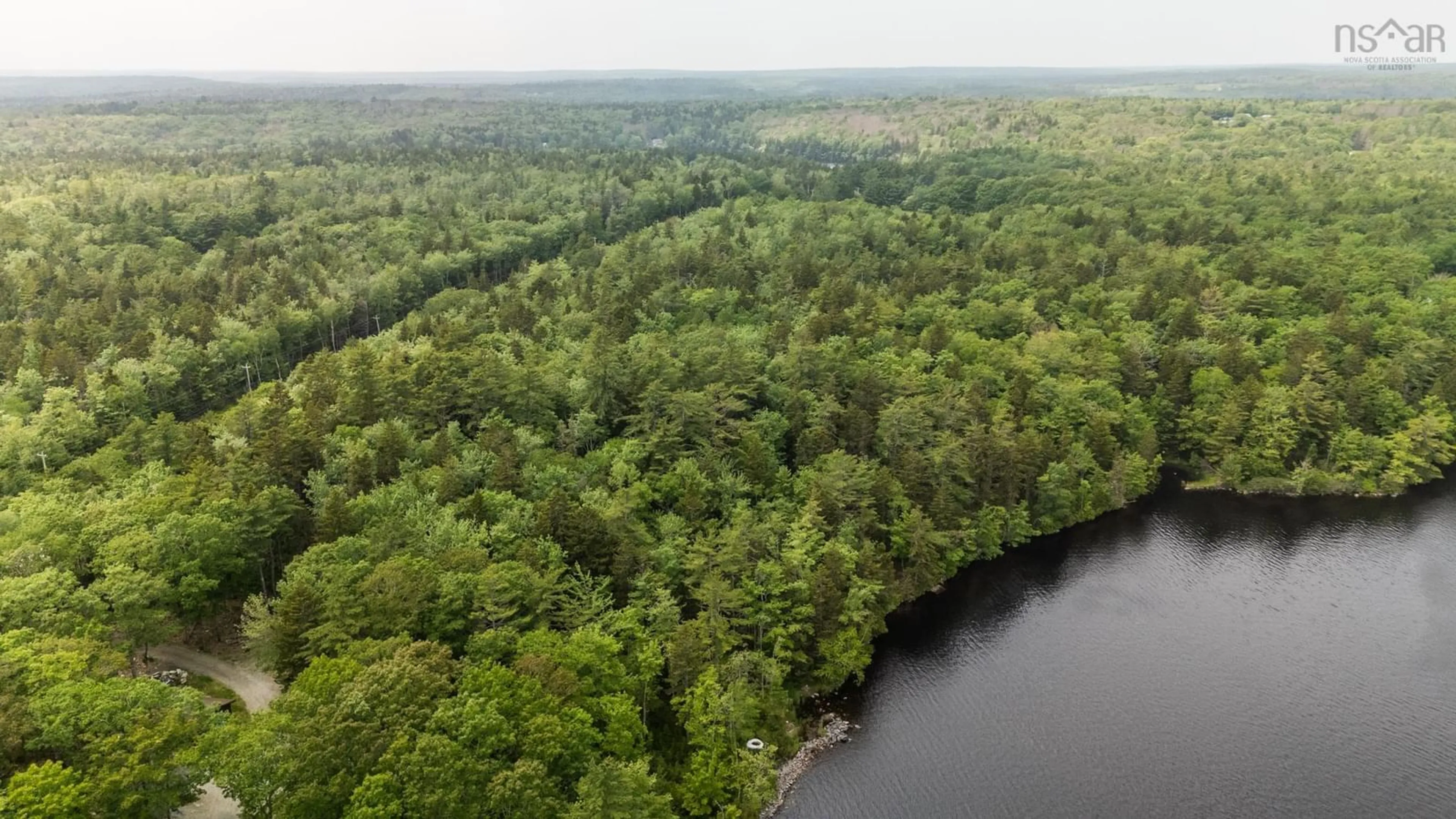 A pic from outside/outdoor area/front of a property/back of a property/a pic from drone, forest/trees view for 589 Highway 203, Carleton Nova Scotia B5A 5P9