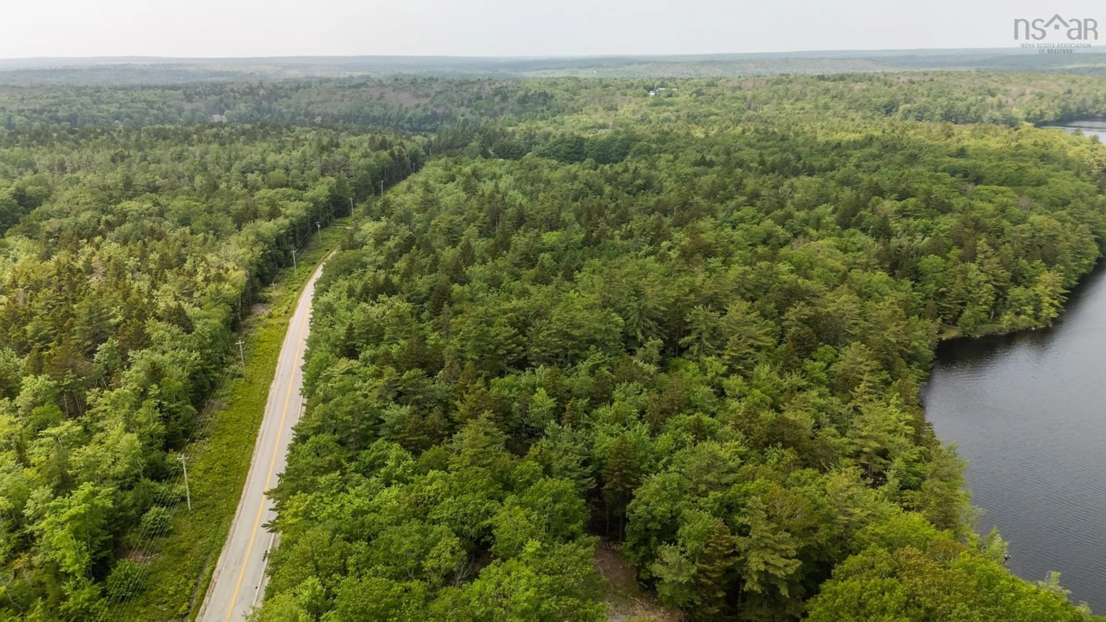 A pic from outside/outdoor area/front of a property/back of a property/a pic from drone, forest/trees view for 589 Highway 203, Carleton Nova Scotia B5A 5P9