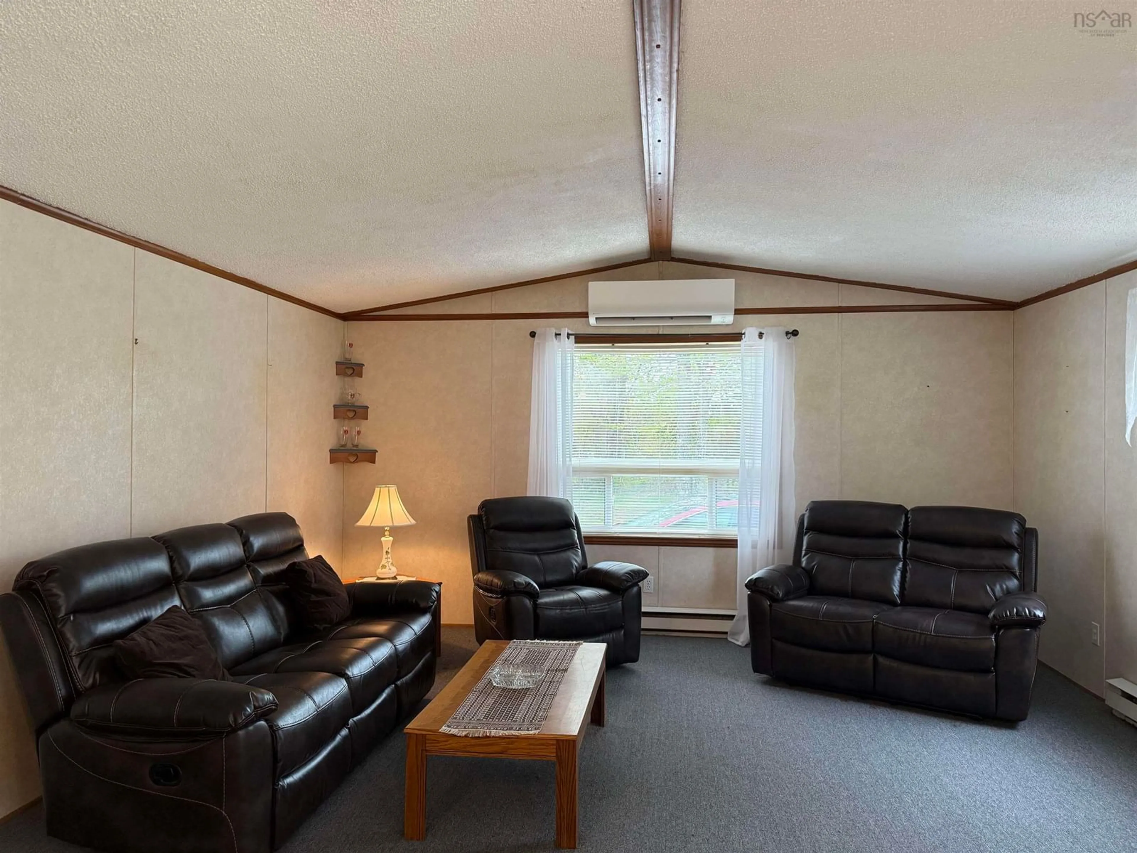 Living room with furniture, wood/laminate floor for 9717 Sherbrooke Rd, Coalburn Nova Scotia B2H 5C7