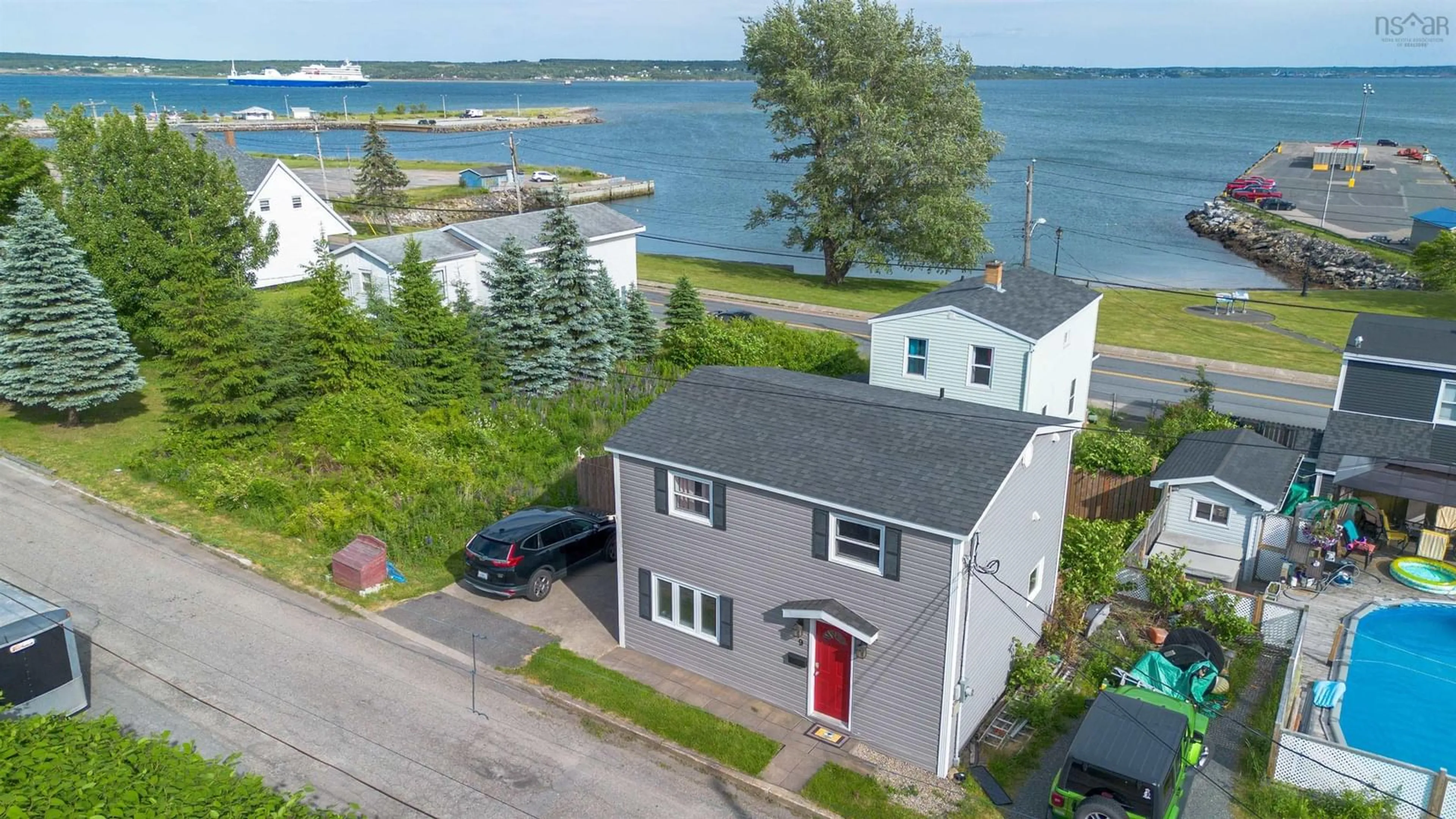 A pic from outside/outdoor area/front of a property/back of a property/a pic from drone, water/lake/river/ocean view for 9 Cogan St, North Sydney Nova Scotia B2A 3A7