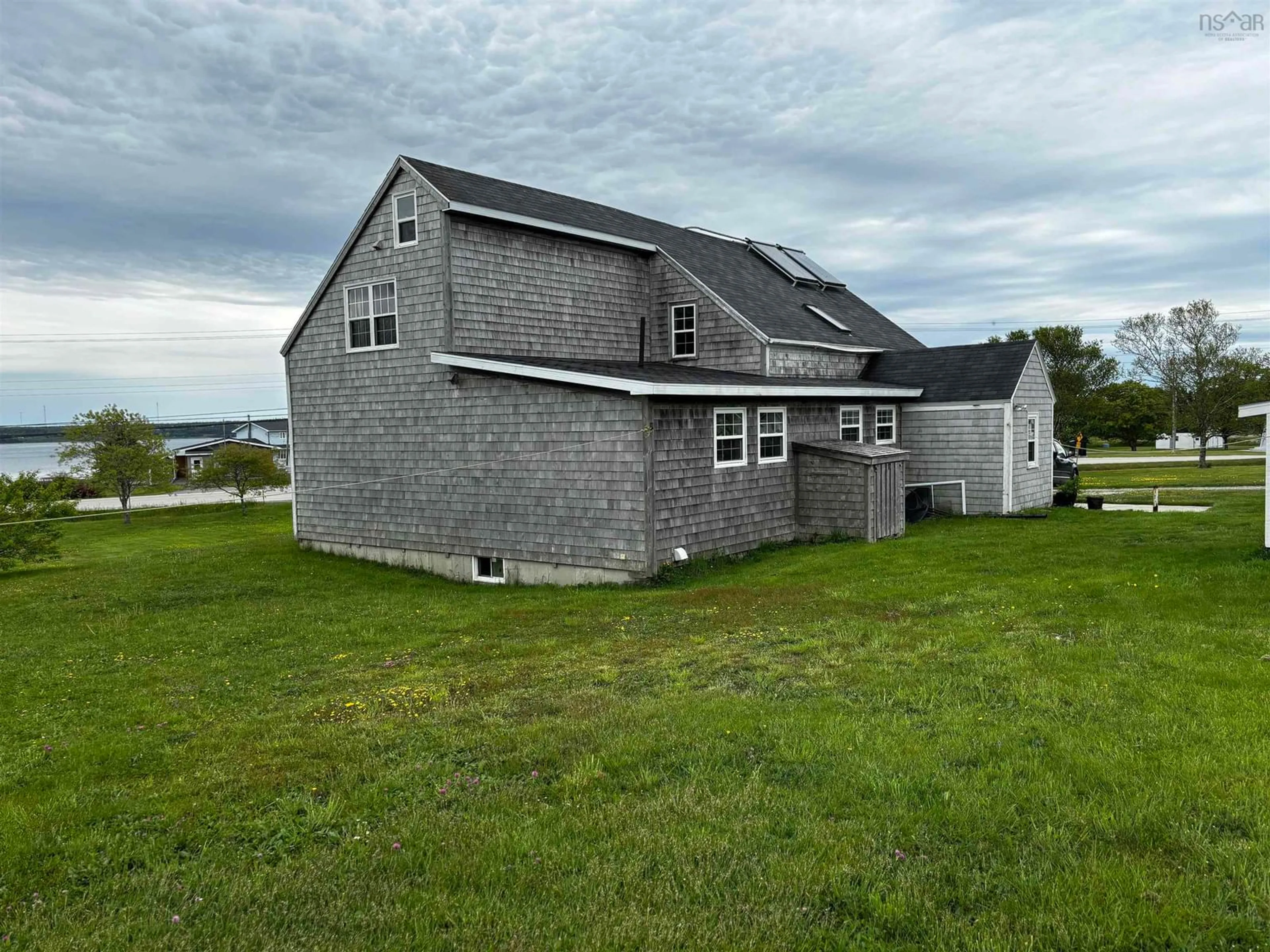 A pic from outside/outdoor area/front of a property/back of a property/a pic from drone, water/lake/river/ocean view for 712 Highway 335, West Pubnico Nova Scotia B0W 3S0
