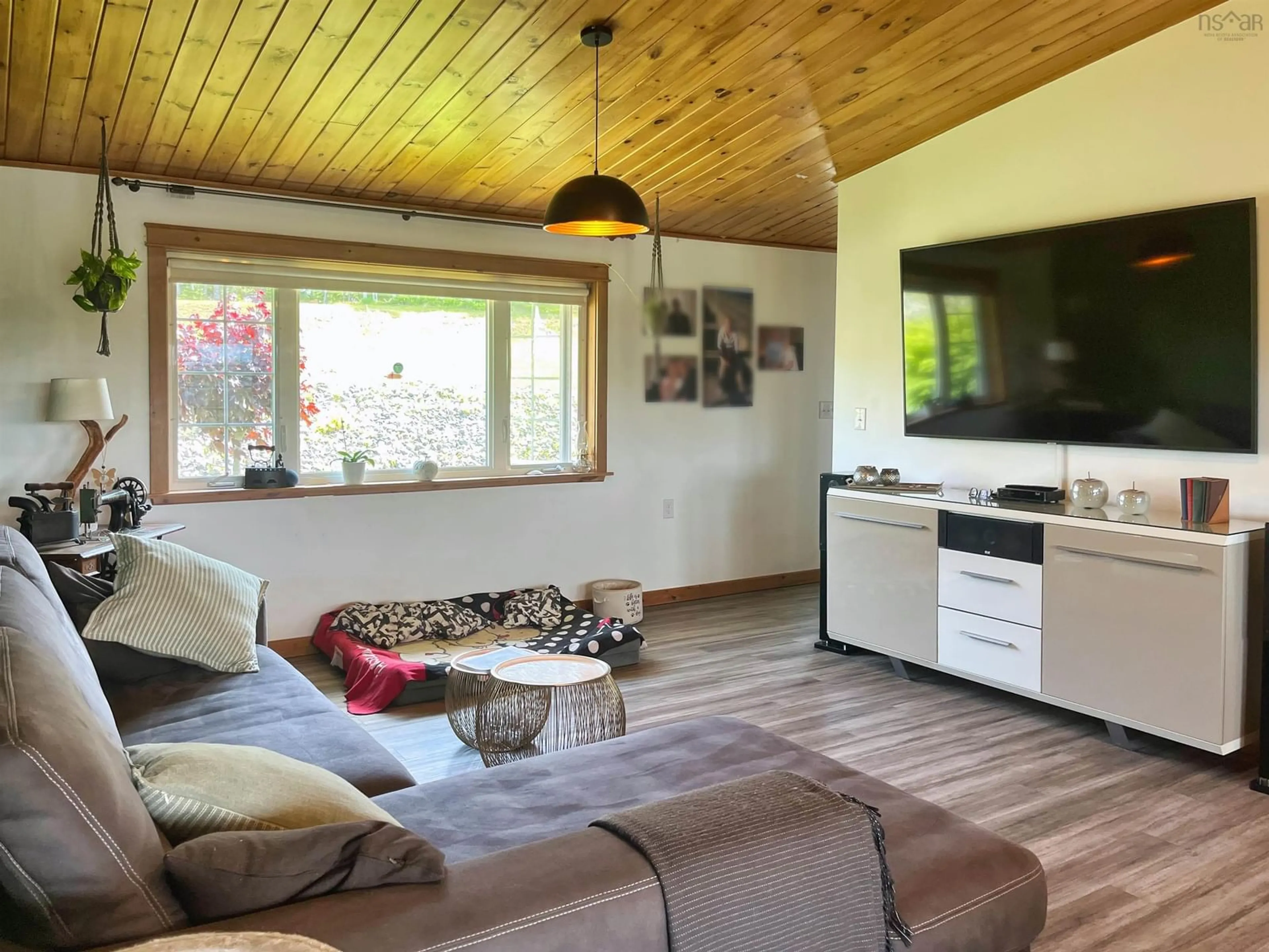 Living room with furniture, wood/laminate floor for 1757 St Peters Fourchu Rd, Grand River Nova Scotia B0E 1M0