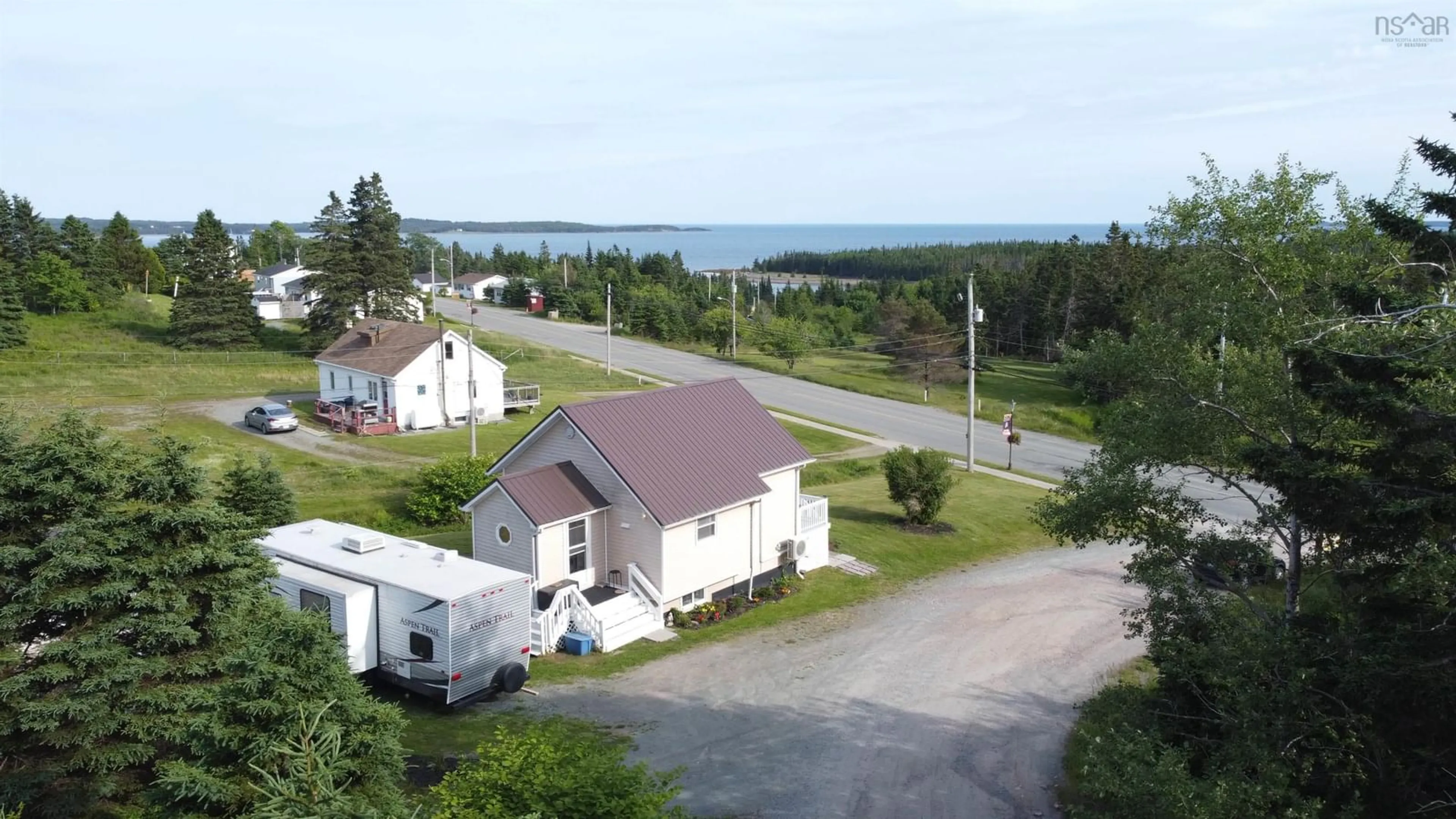A pic from outside/outdoor area/front of a property/back of a property/a pic from drone, water/lake/river/ocean view for 9653 Grenville St, St. Peter's Nova Scotia B0E 3B0