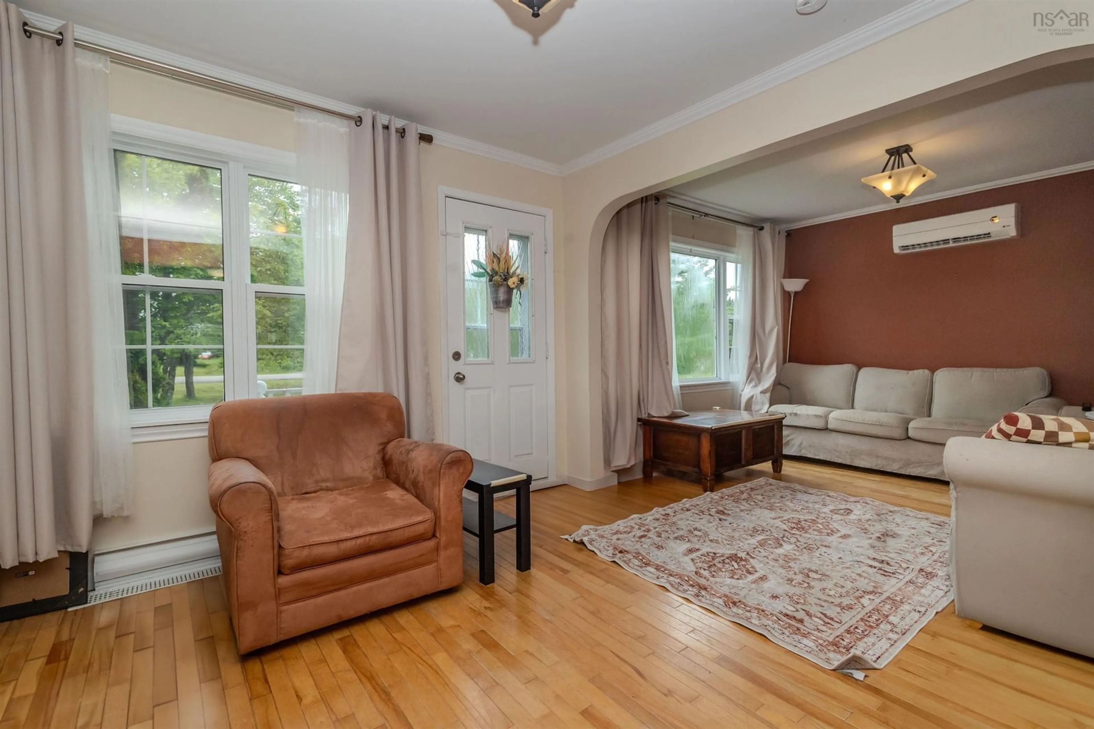 Living room with furniture, wood/laminate floor for 688 Morrison Rd, Sydney Nova Scotia B1M 1B7