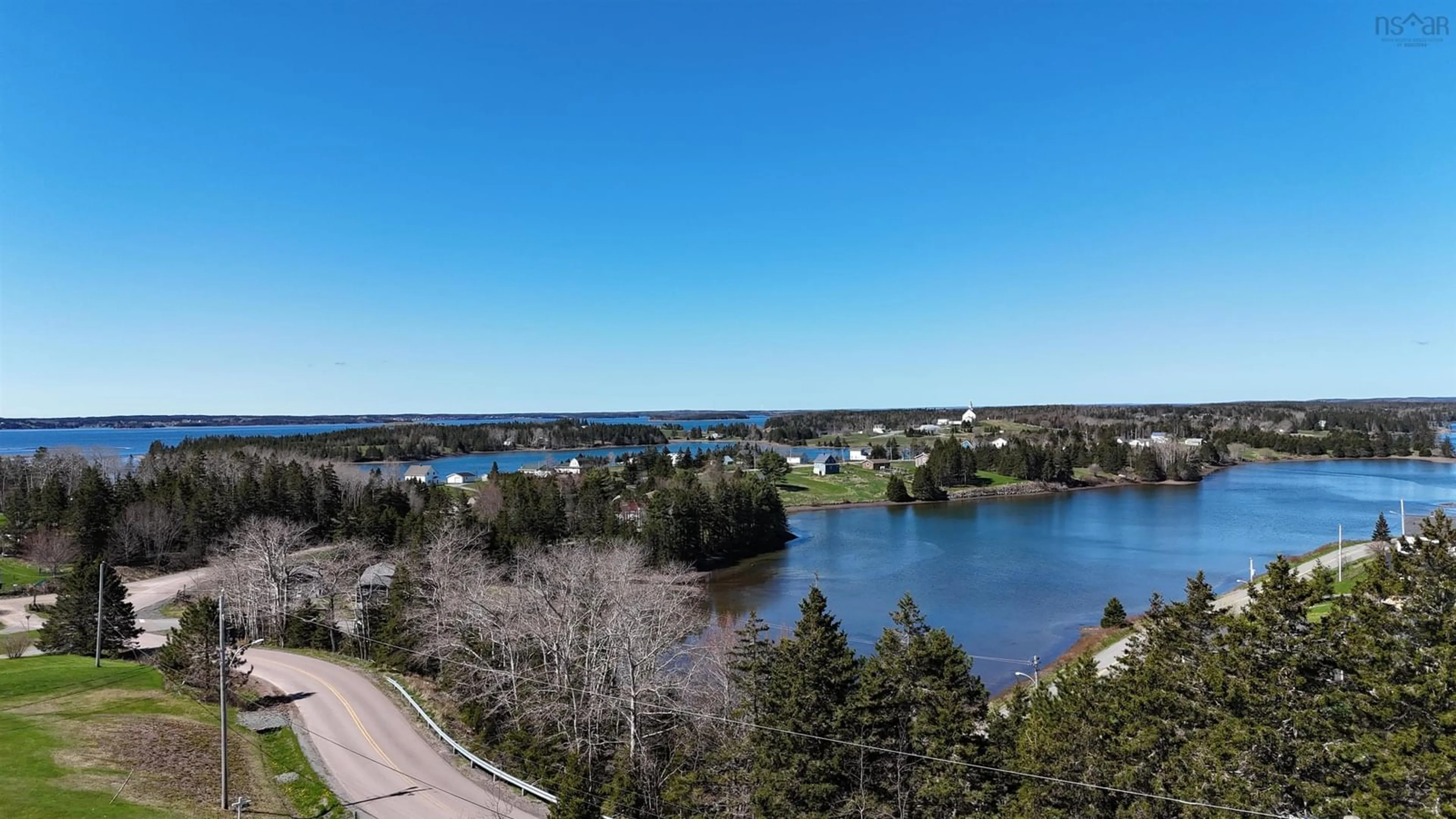 A pic from outside/outdoor area/front of a property/back of a property/a pic from drone, water/lake/river/ocean view for 95 Church Point Road, River Bourgeois Nova Scotia B0E 2X0