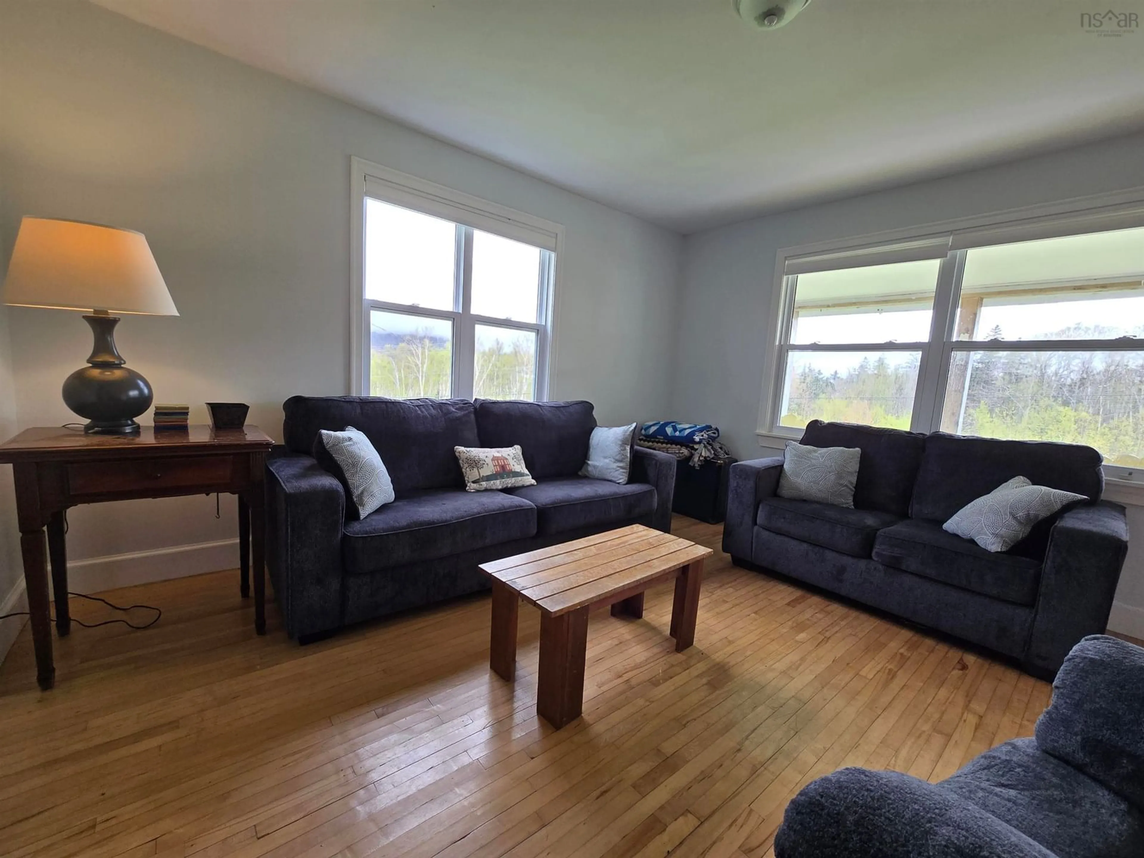 Living room with furniture, wood/laminate floor for 217 Bay St Lawrence Rd, Cape North Nova Scotia B0C 1G0