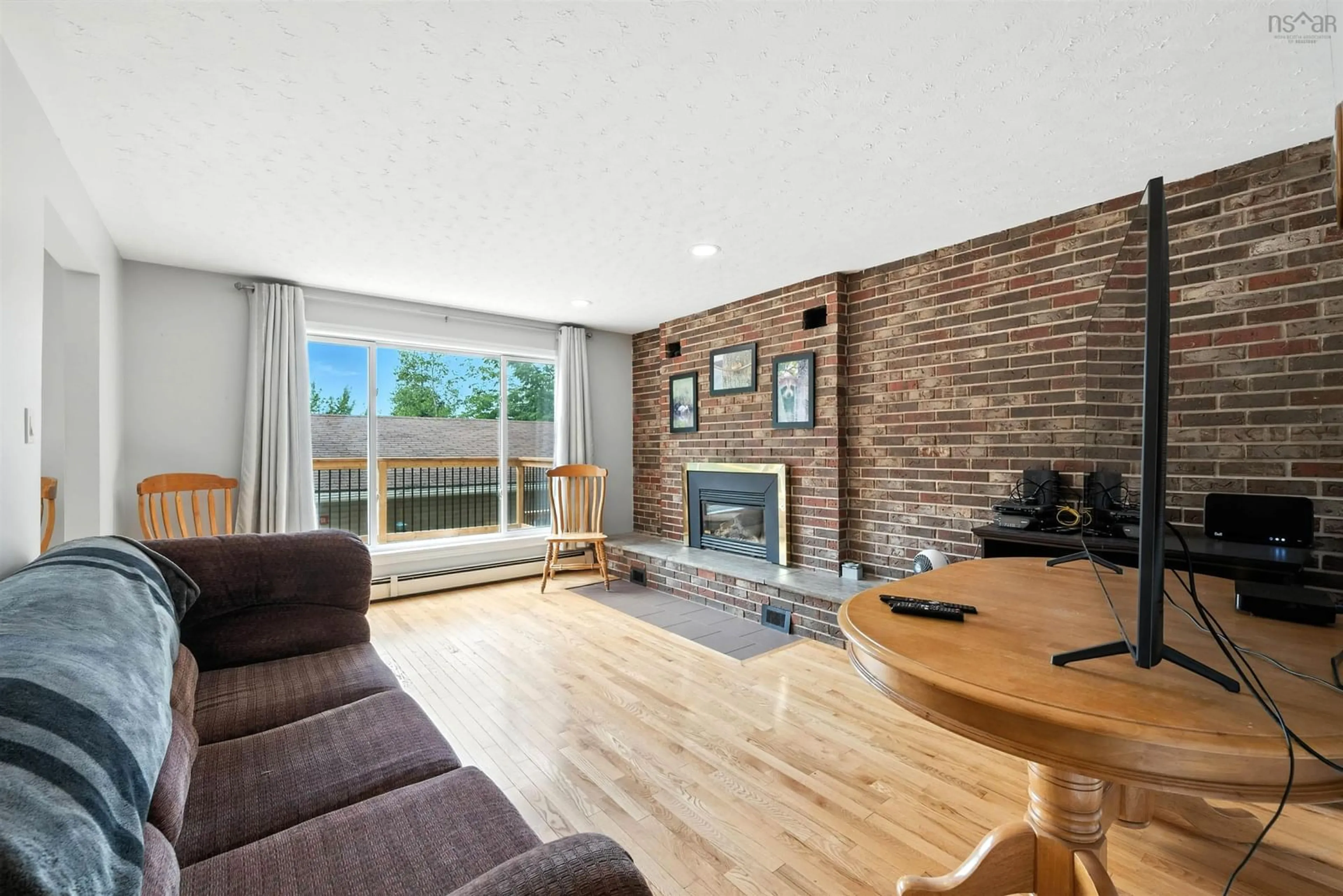 Living room with furniture, wood/laminate floor for 92 First St, Middle Sackville Nova Scotia B4E 1T1