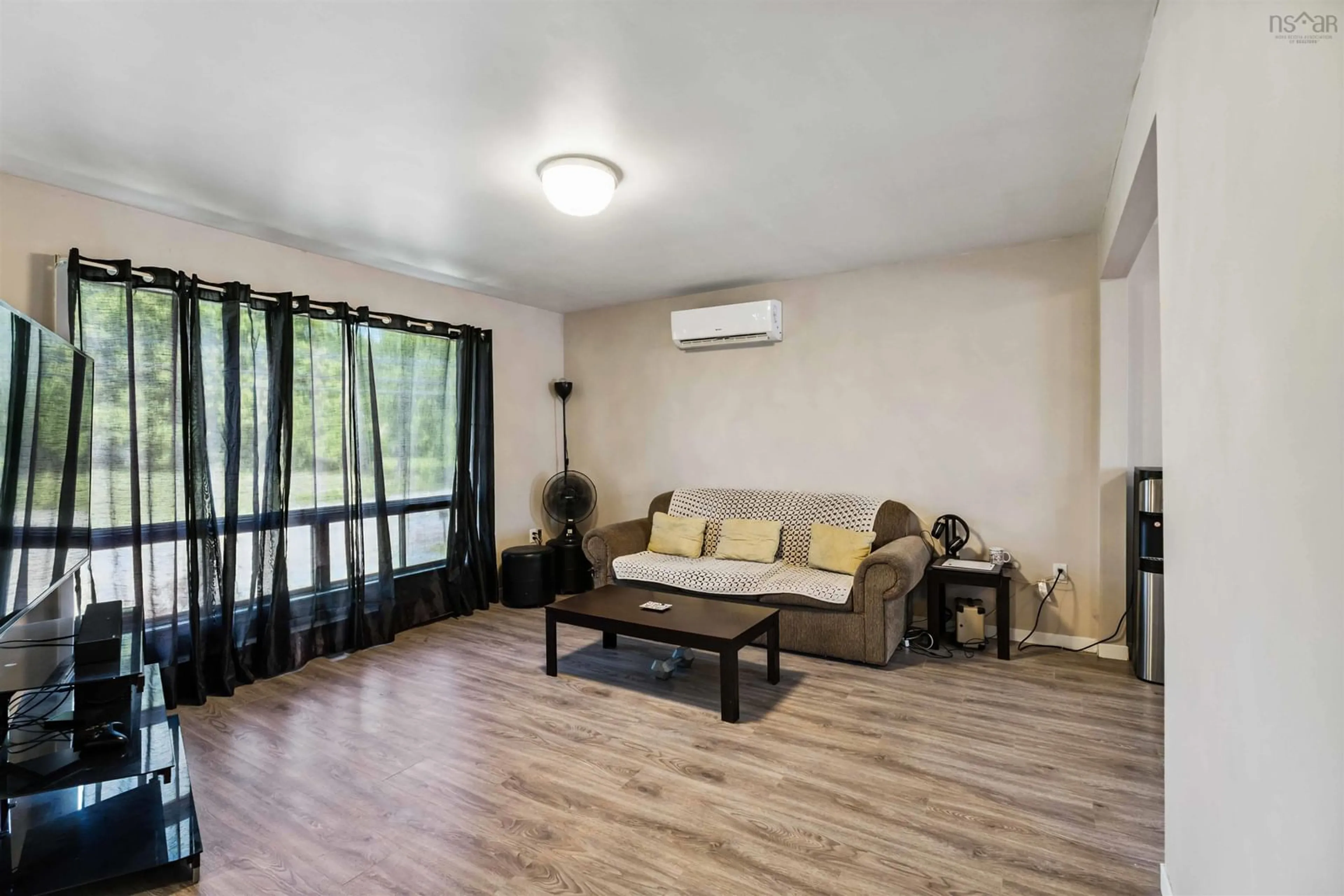Living room with furniture, wood/laminate floor for 4632 Highway 1, Three Mile Plains Nova Scotia B0N 2T0