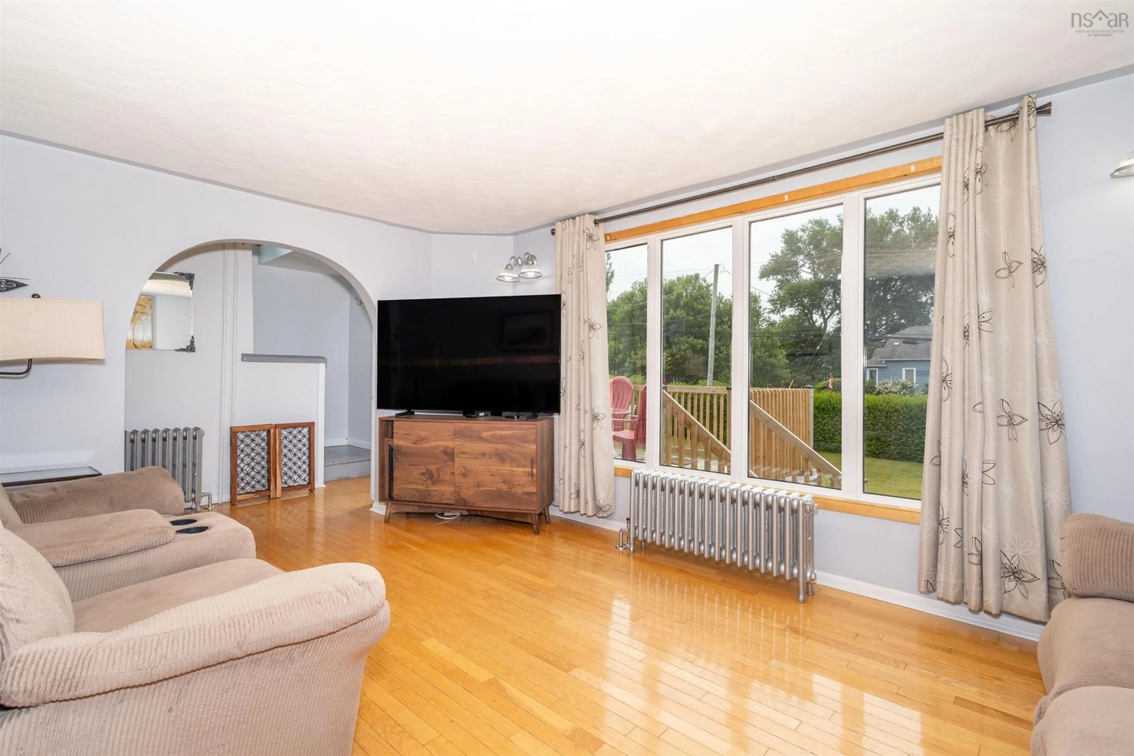 Living room with furniture, wood/laminate floor for 3 Browns Rd, New Victoria Nova Scotia B1H 4Y4