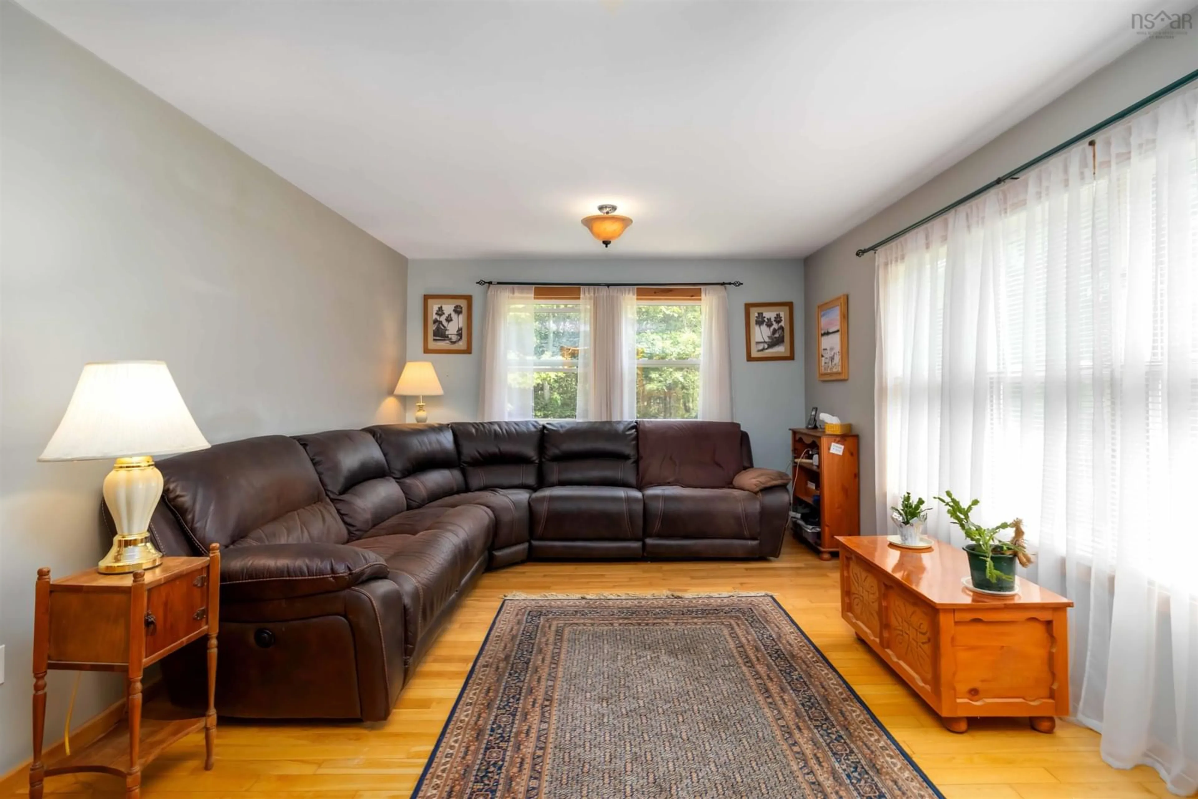 Living room with furniture, wood/laminate floor for 6736 Highway 3, Martins Point Nova Scotia B0J 2E0