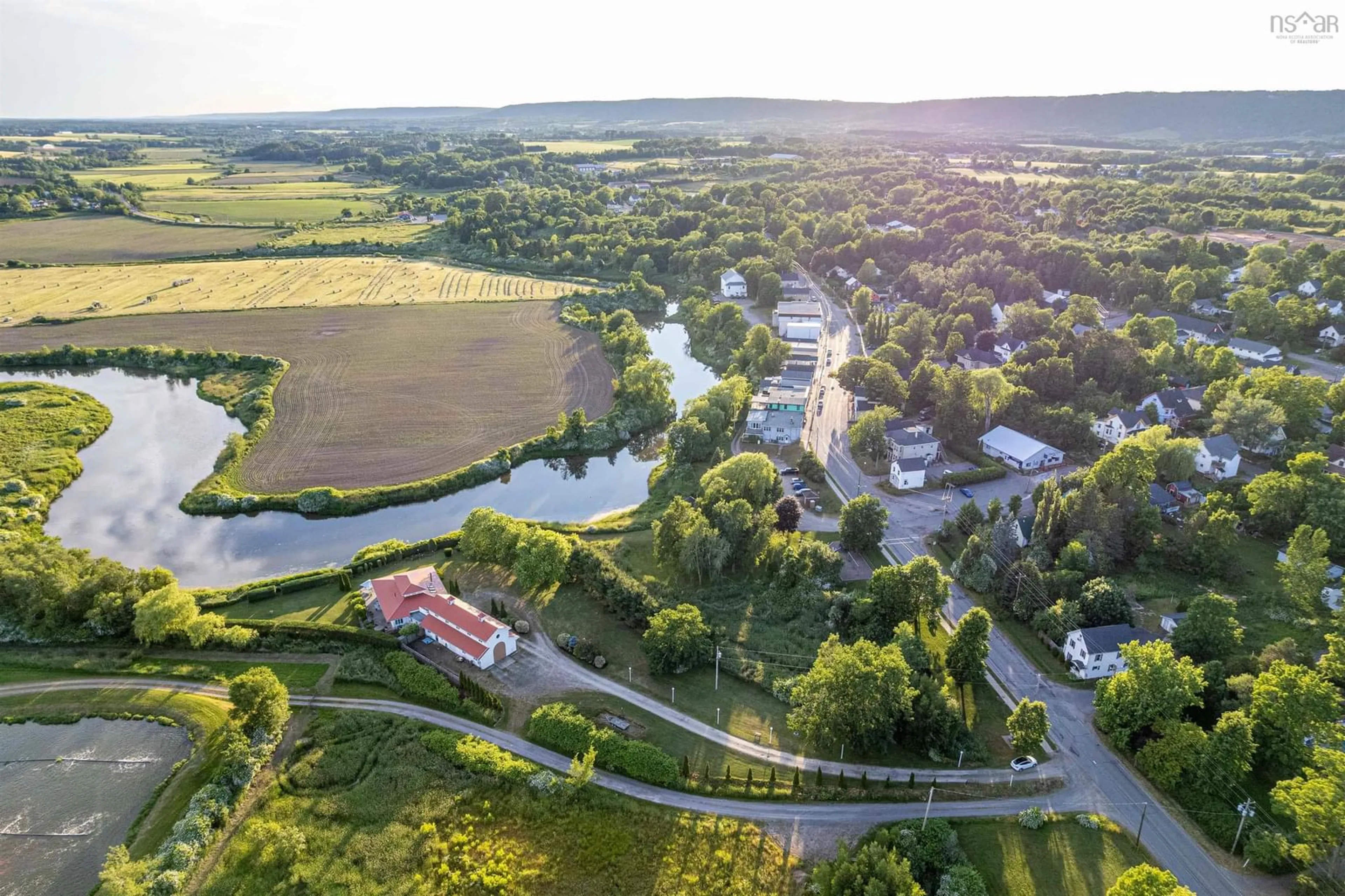 A pic from outside/outdoor area/front of a property/back of a property/a pic from drone, water/lake/river/ocean view for 9878 Main St, Canning Nova Scotia B0P 1H0