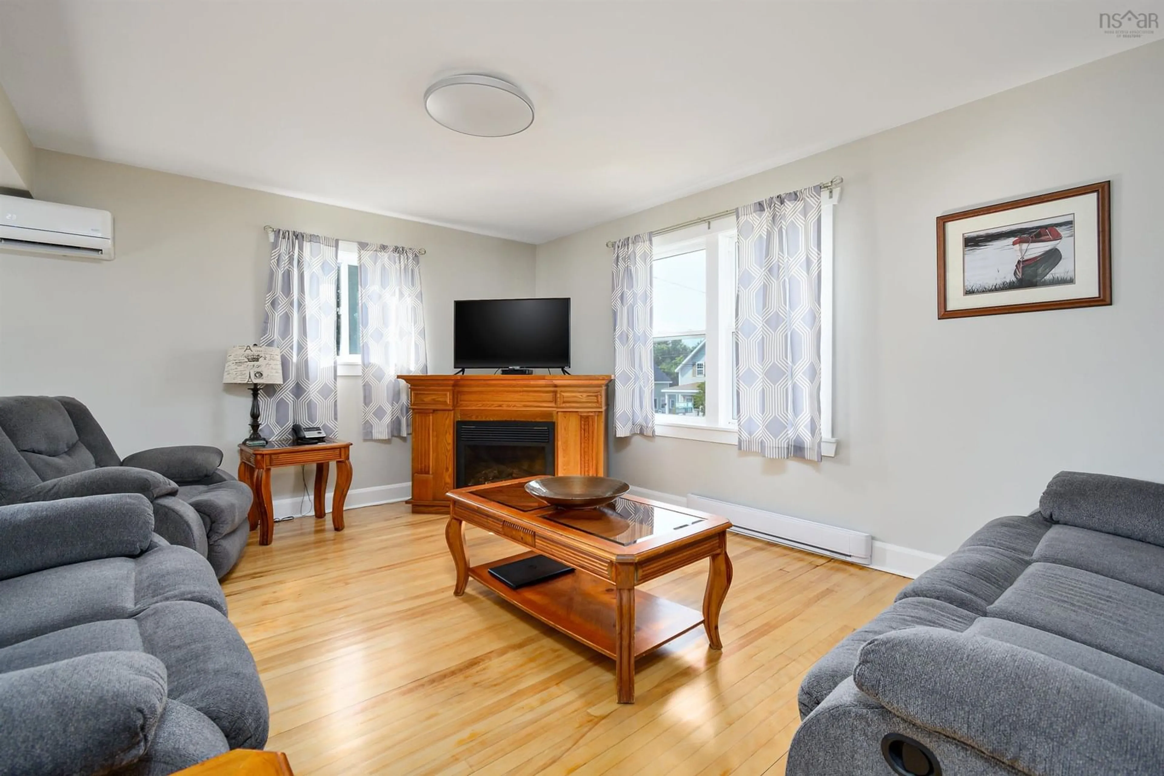 Living room with furniture, wood/laminate floor for 3490 Ellsworth Ave, New Waterford Nova Scotia B1H 2G5
