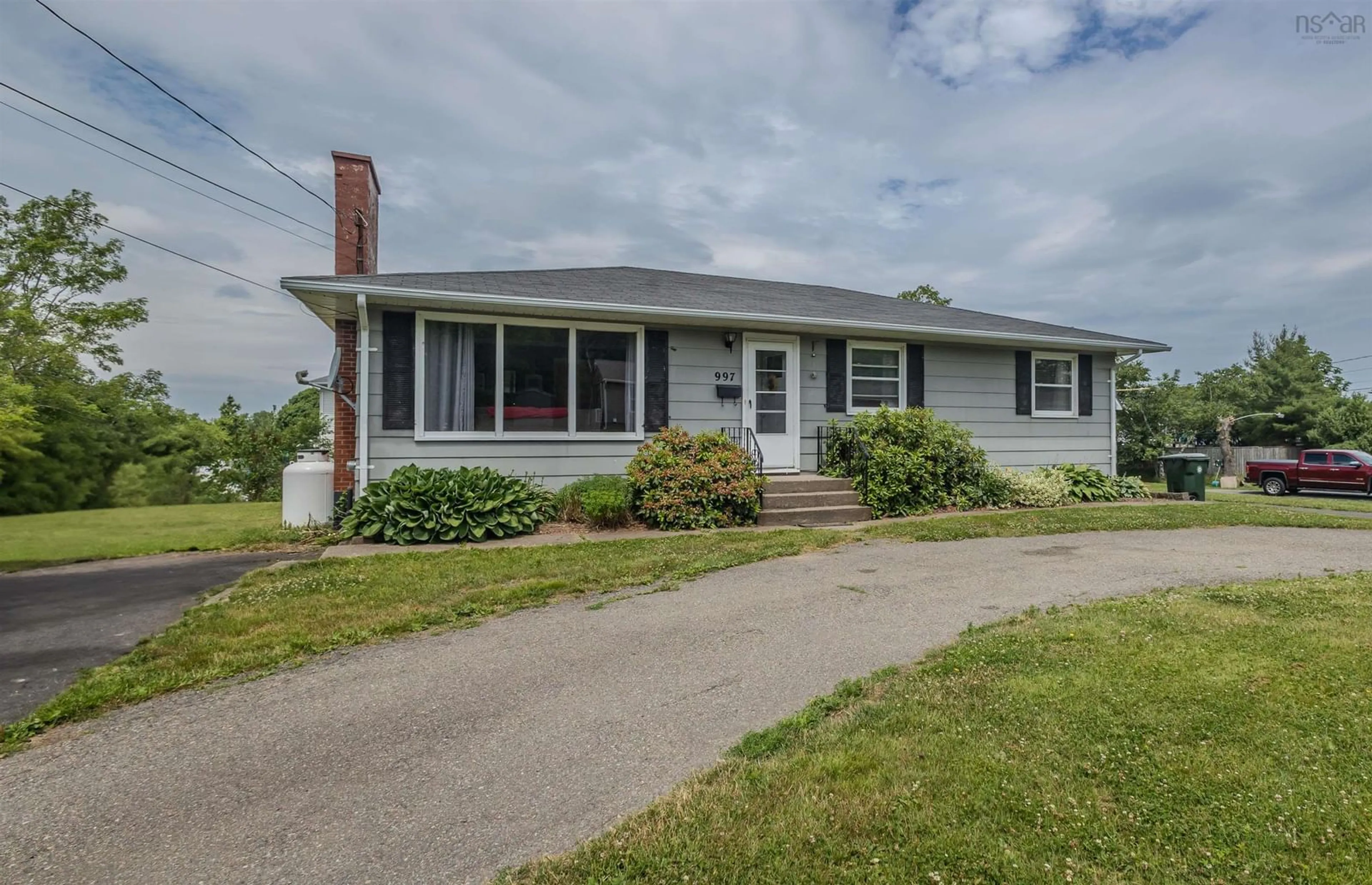 Home with vinyl exterior material, street for 997 Upper Prince St, Sydney Nova Scotia B1P 5P3