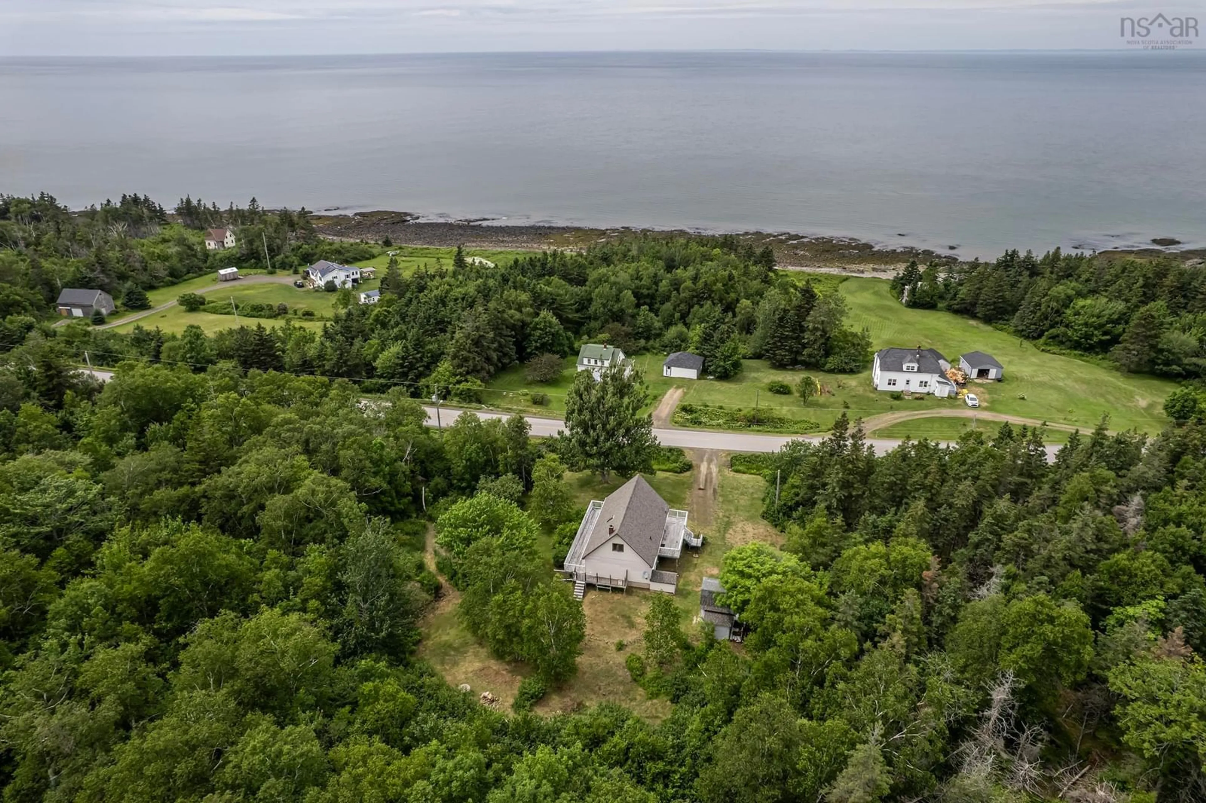 A pic from outside/outdoor area/front of a property/back of a property/a pic from drone, water/lake/river/ocean view for 6092 Shore Rd, Youngs Cove Nova Scotia B0S 1L0