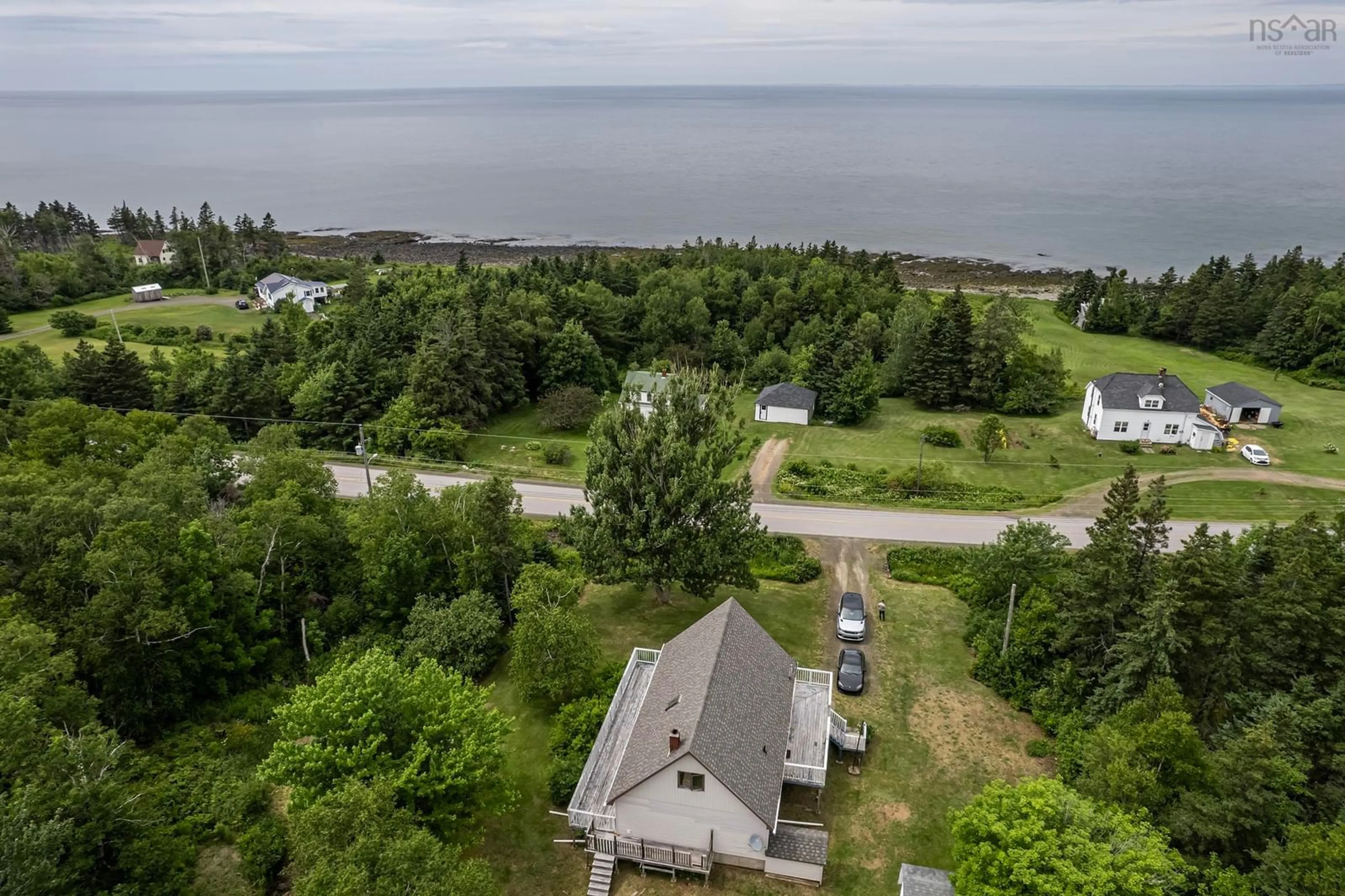 A pic from outside/outdoor area/front of a property/back of a property/a pic from drone, water/lake/river/ocean view for 6092 Shore Rd, Youngs Cove Nova Scotia B0S 1L0