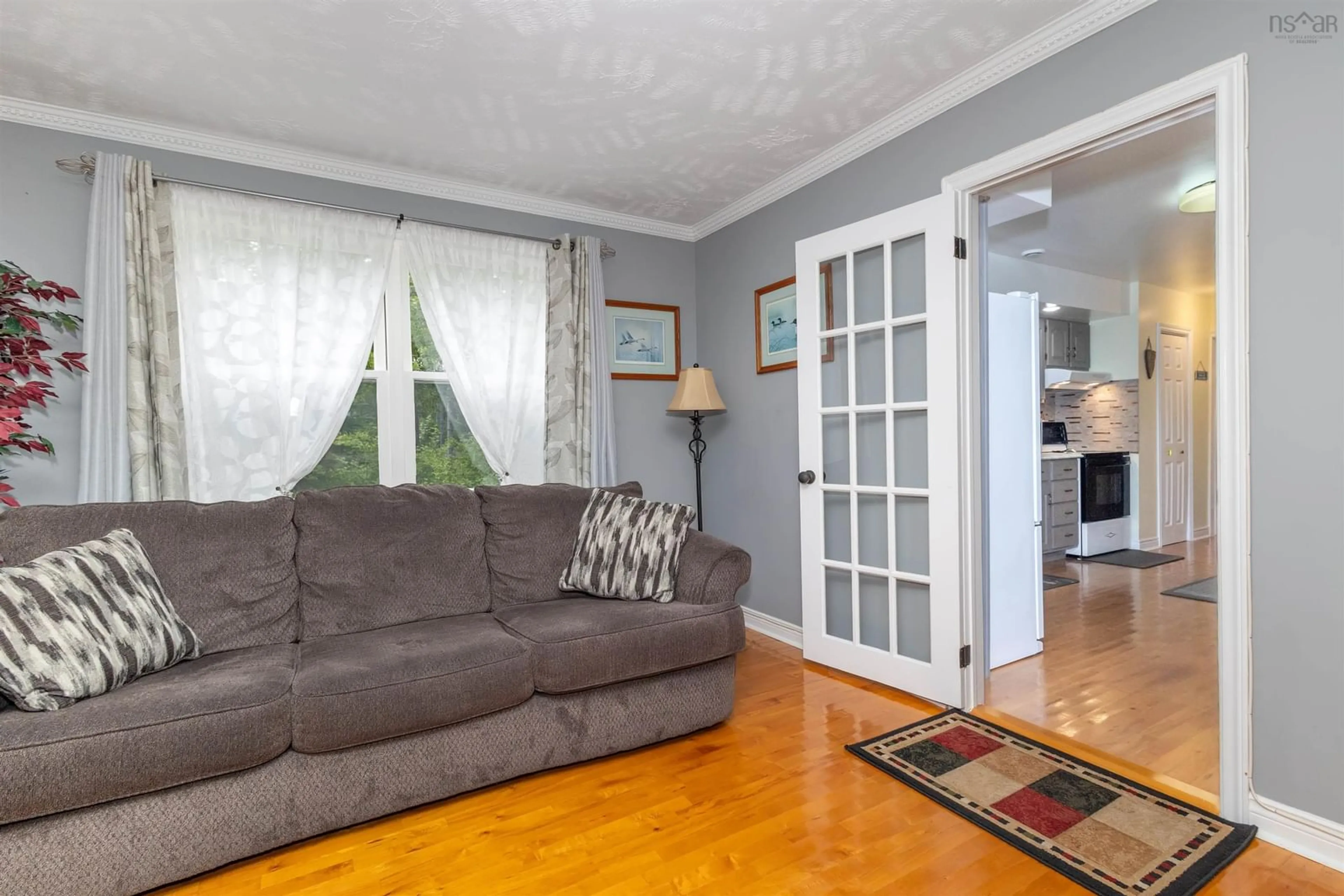 Living room with furniture, wood/laminate floor for 24 Birchwood Heights, Albert Bridge Nova Scotia B1K 3G7