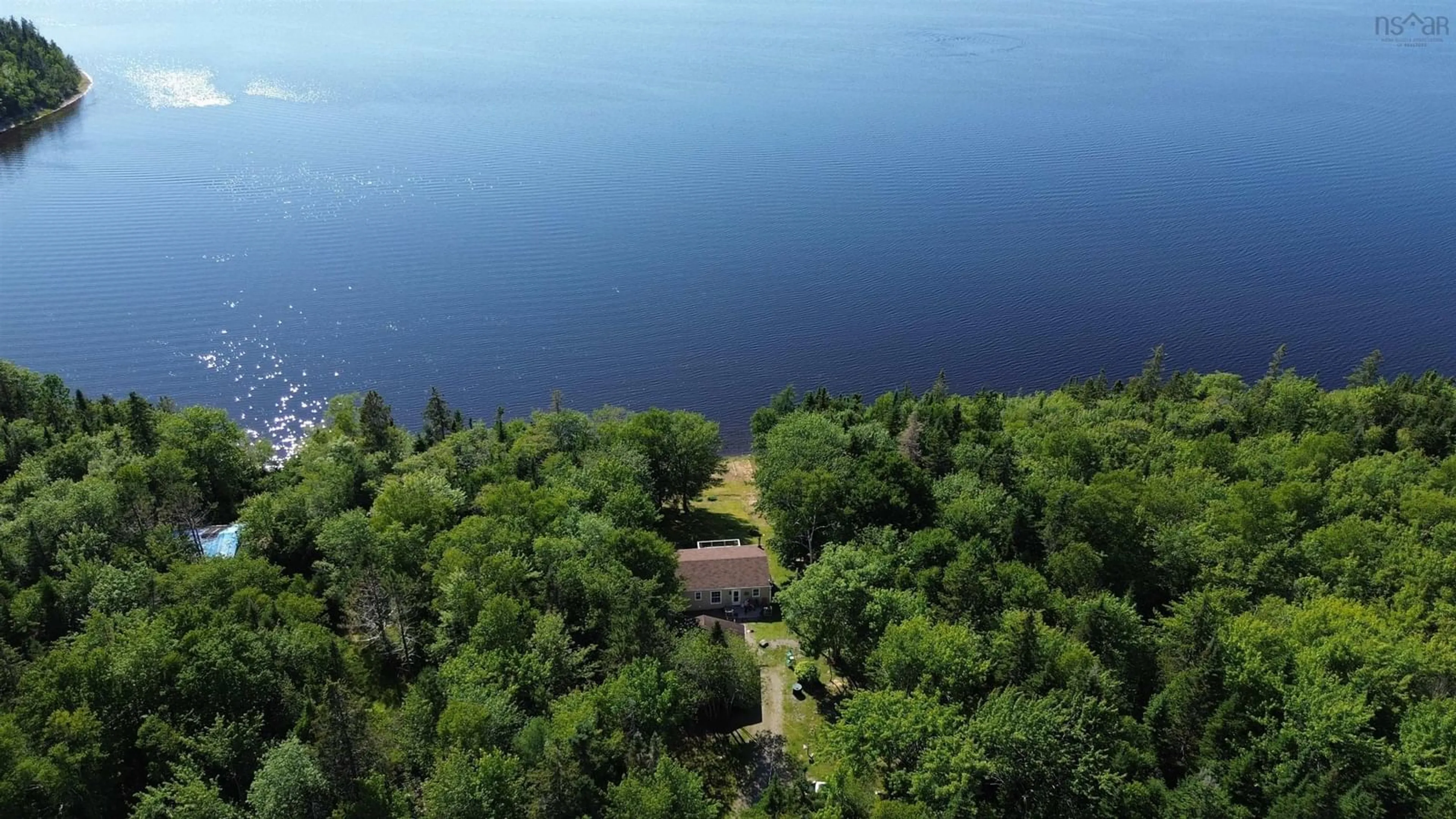 A pic from outside/outdoor area/front of a property/back of a property/a pic from drone, water/lake/river/ocean view for 1458 Grand Mira South Rd, Grand Mira South Nova Scotia B1K 1H2