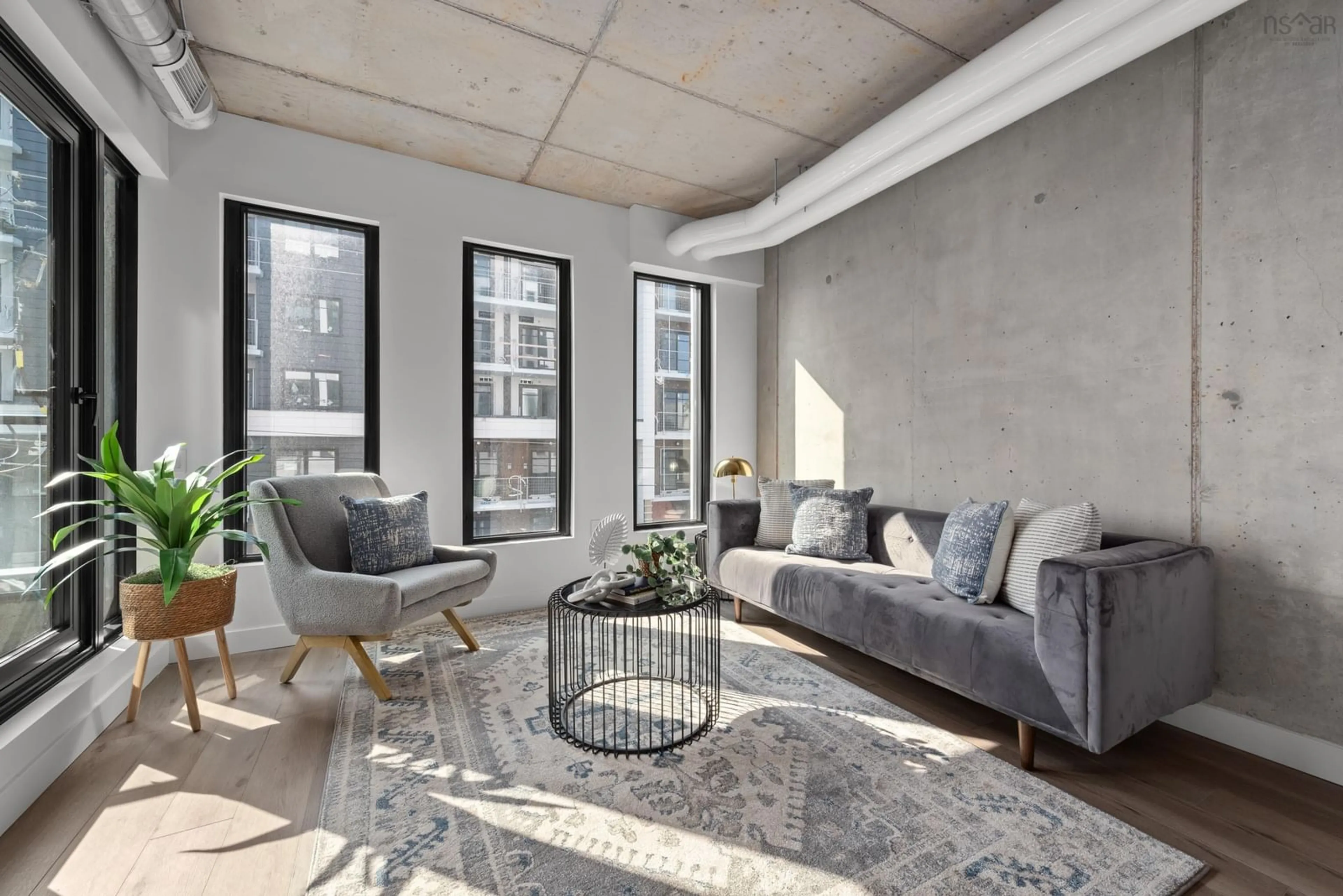 Living room with furniture, cement floor for 5511 Bilby St #302, Halifax Nova Scotia B3K 0M5