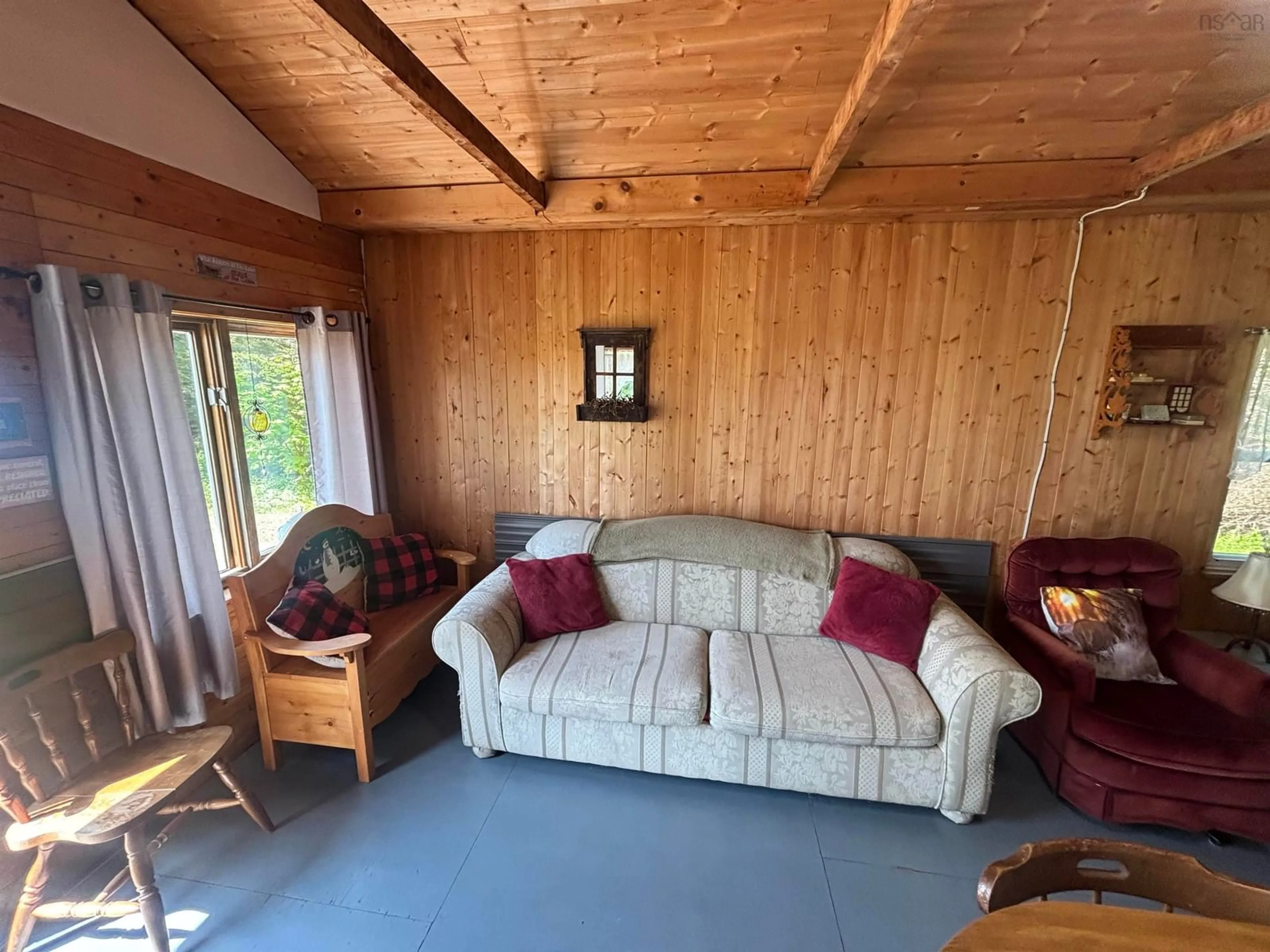 Living room with furniture, wood/laminate floor for 517 Glasgow Mountain Road Rd, Diligent River Nova Scotia B0M 1S0
