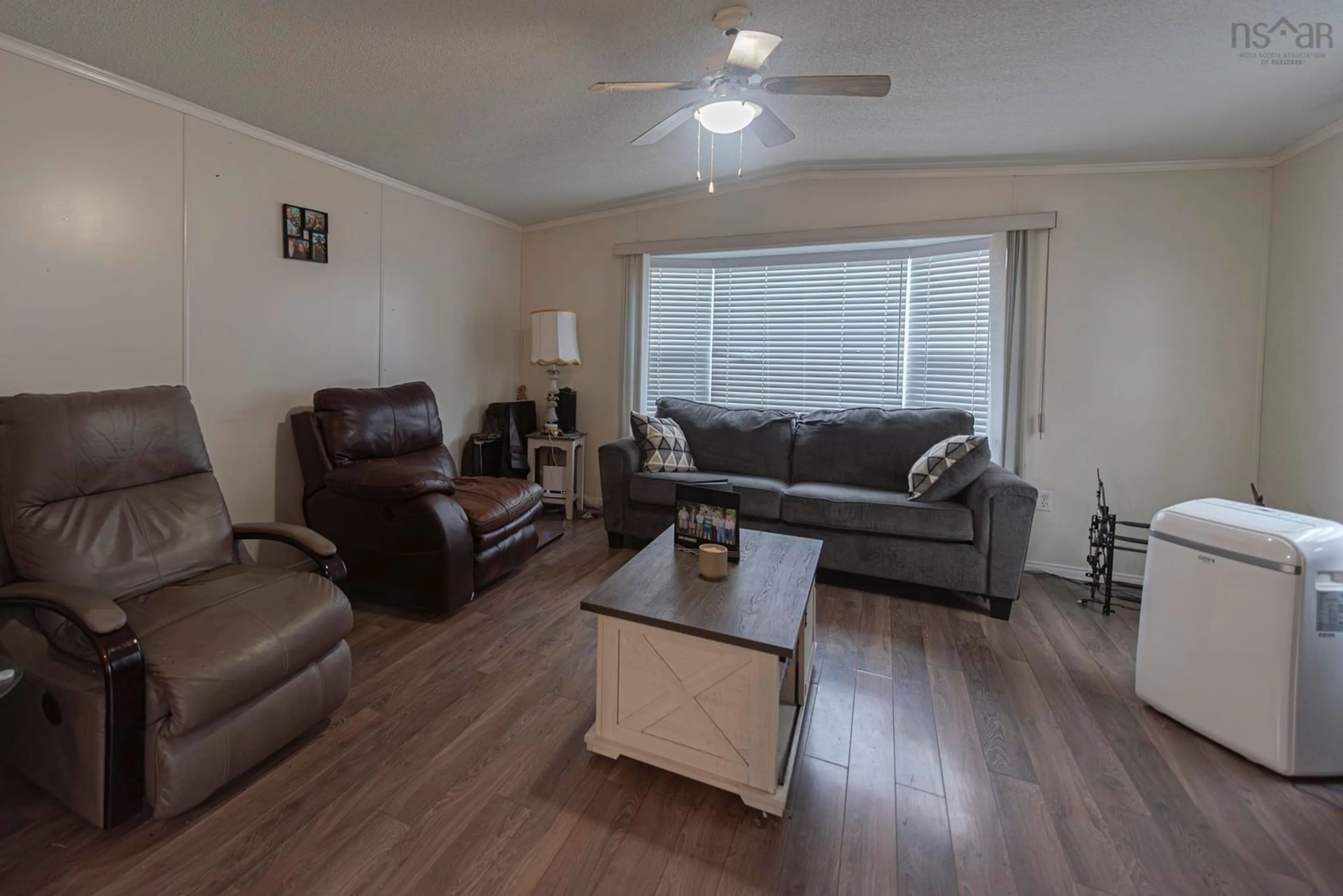 Living room with furniture, wood/laminate floor for 10 High Street Estates, New Glasgow Nova Scotia B2H 4B8